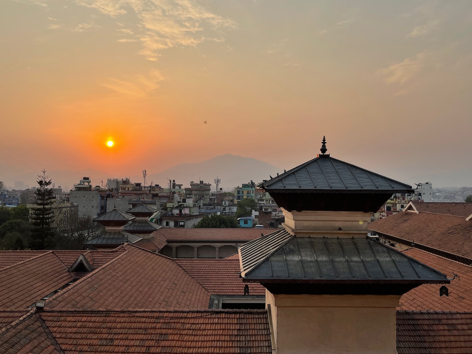 rooftop rooftops of a city with a sunset in the background