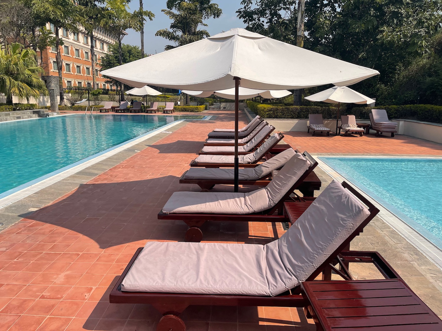 a pool with chairs and umbrellas