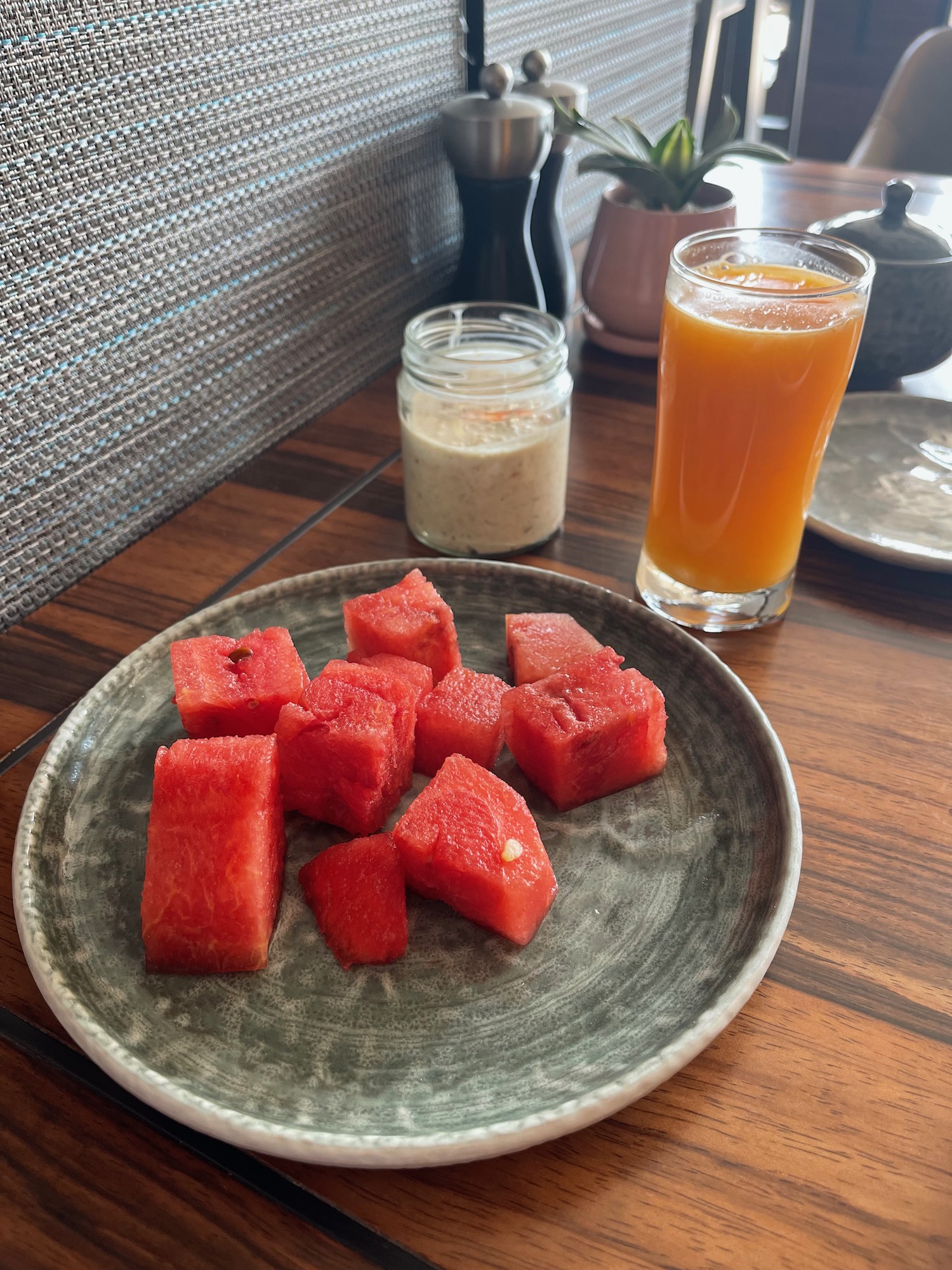 a plate of watermelon and a glass of juice