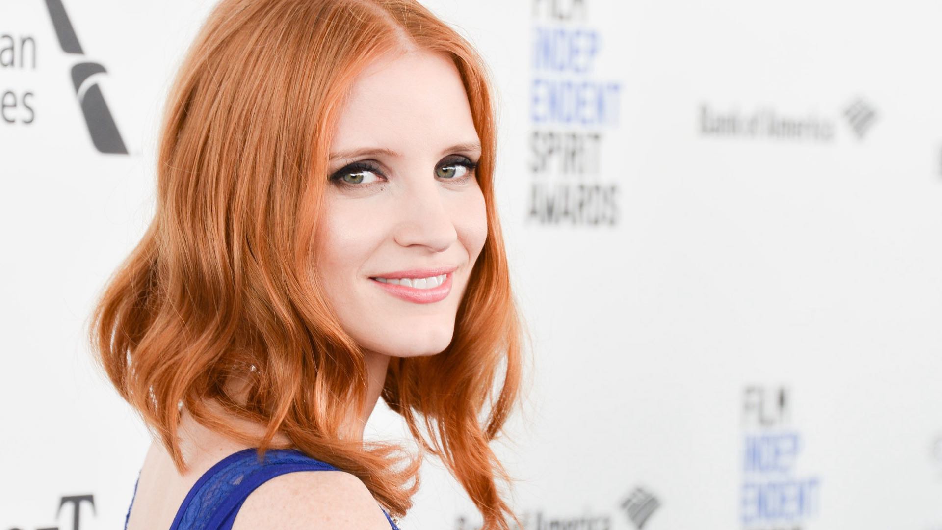 a woman with red hair smiling