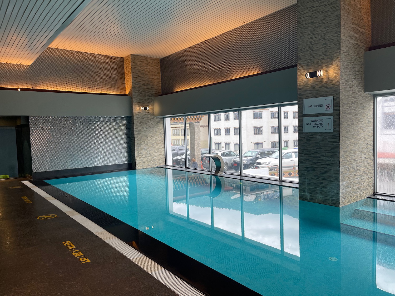 a indoor pool with a large window