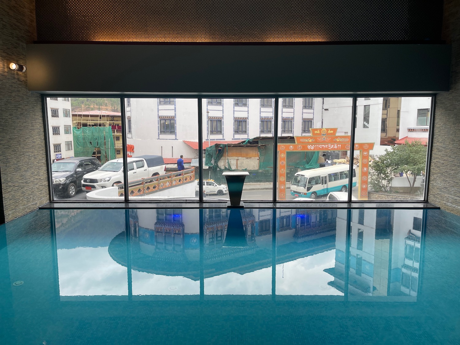 a pool with a view of a city and cars