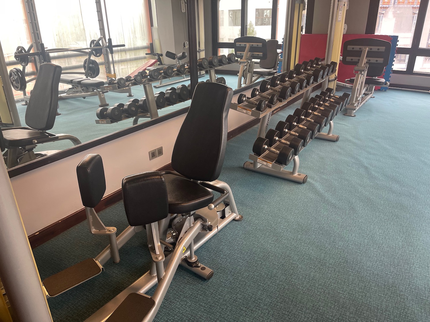 a room with weights and a row of chairs