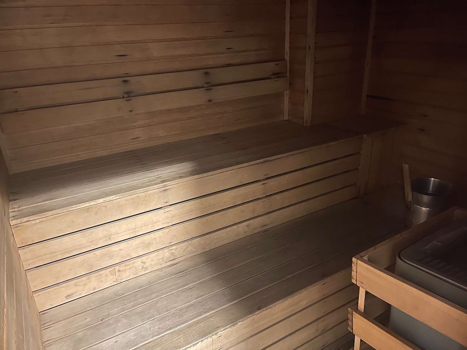 a wooden sauna with a bucket and a bucket