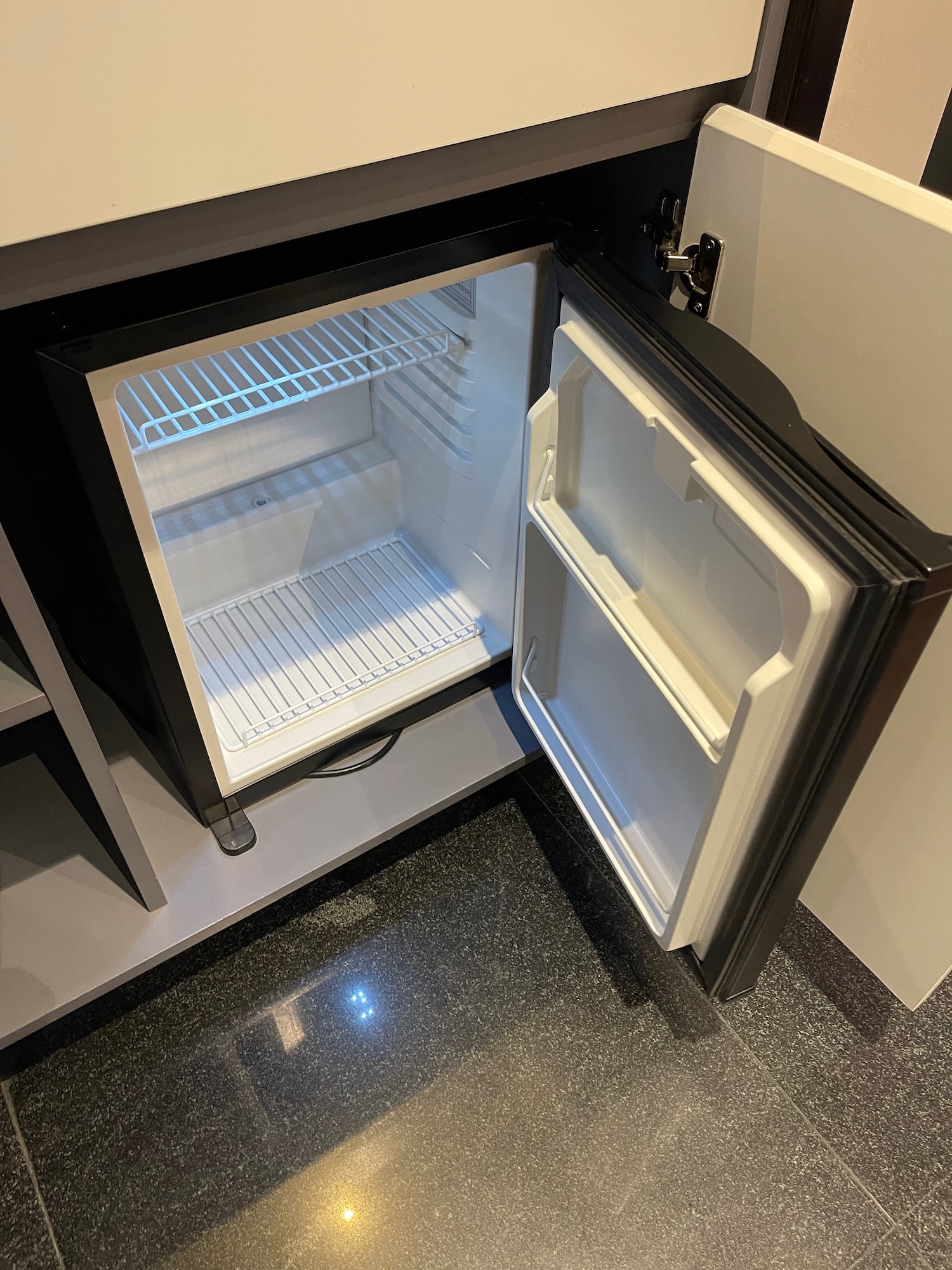 a small refrigerator with a door open