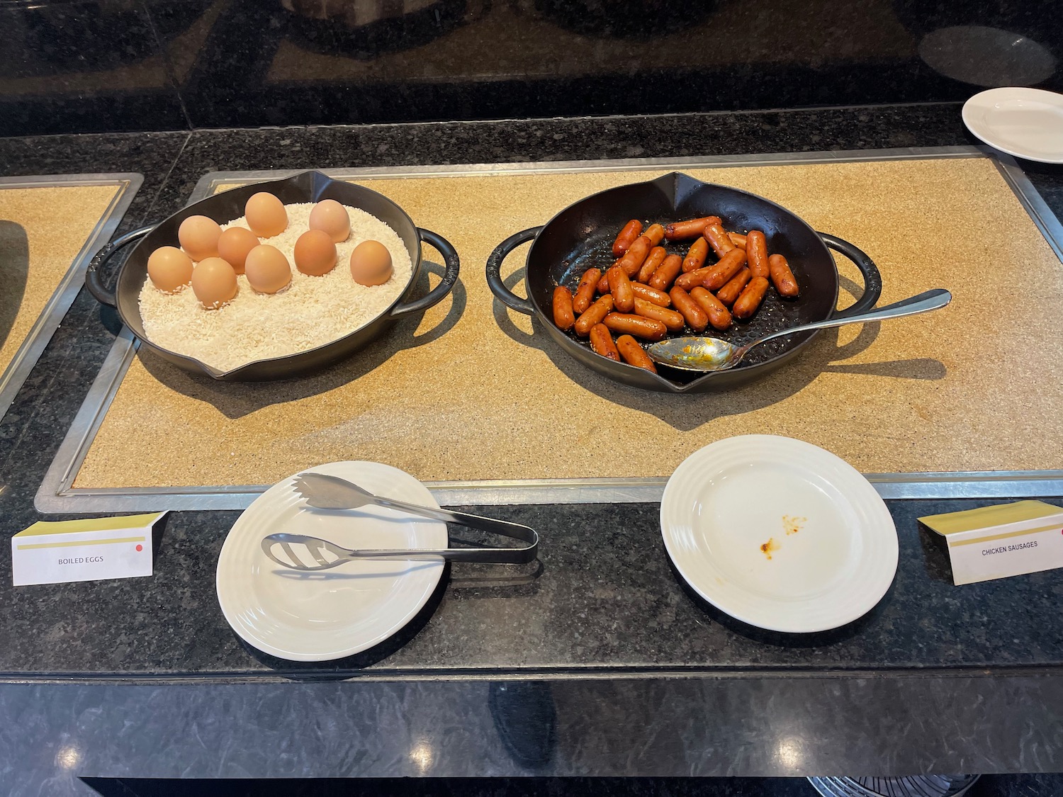 a pans with food in it and a plate with utensils