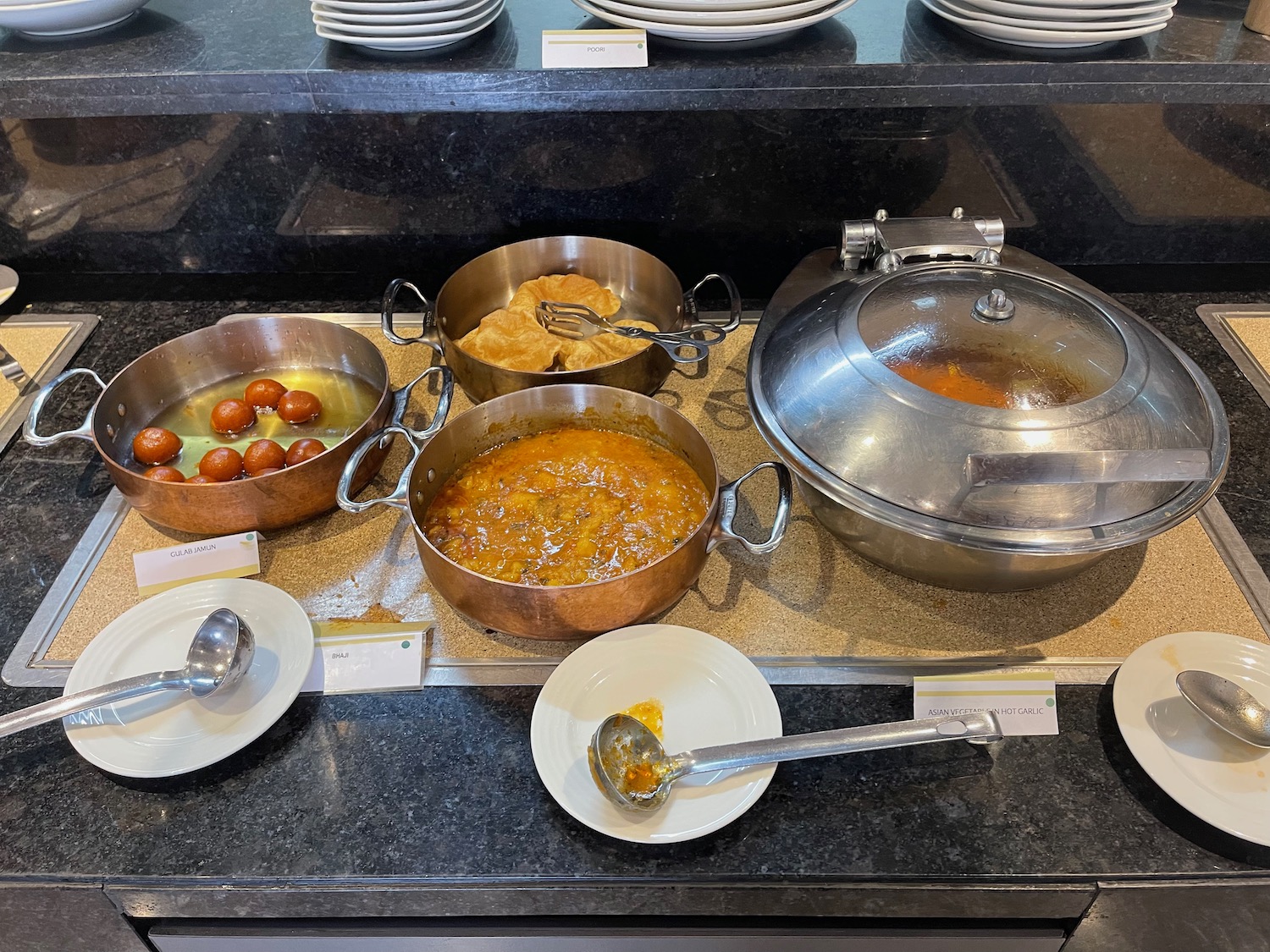 a group of pots with food on a counter