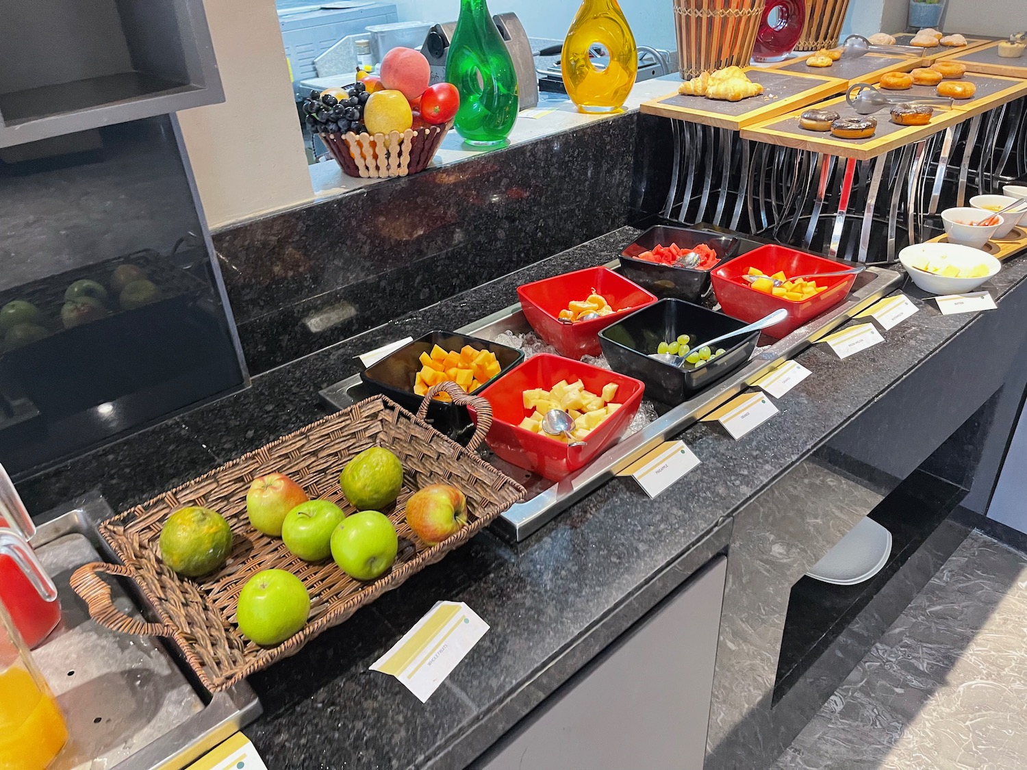 a buffet line with fruit in baskets