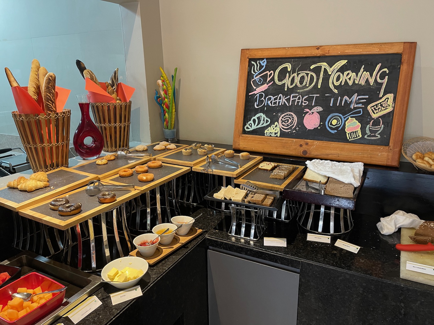 a breakfast buffet with a chalkboard