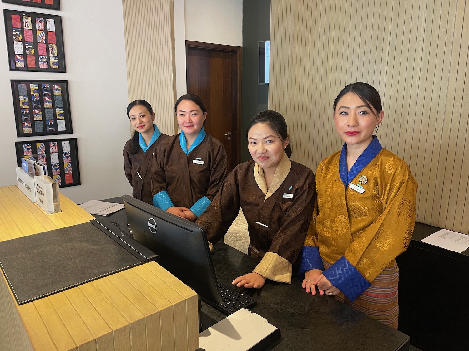 a group of women standing in front of a computer