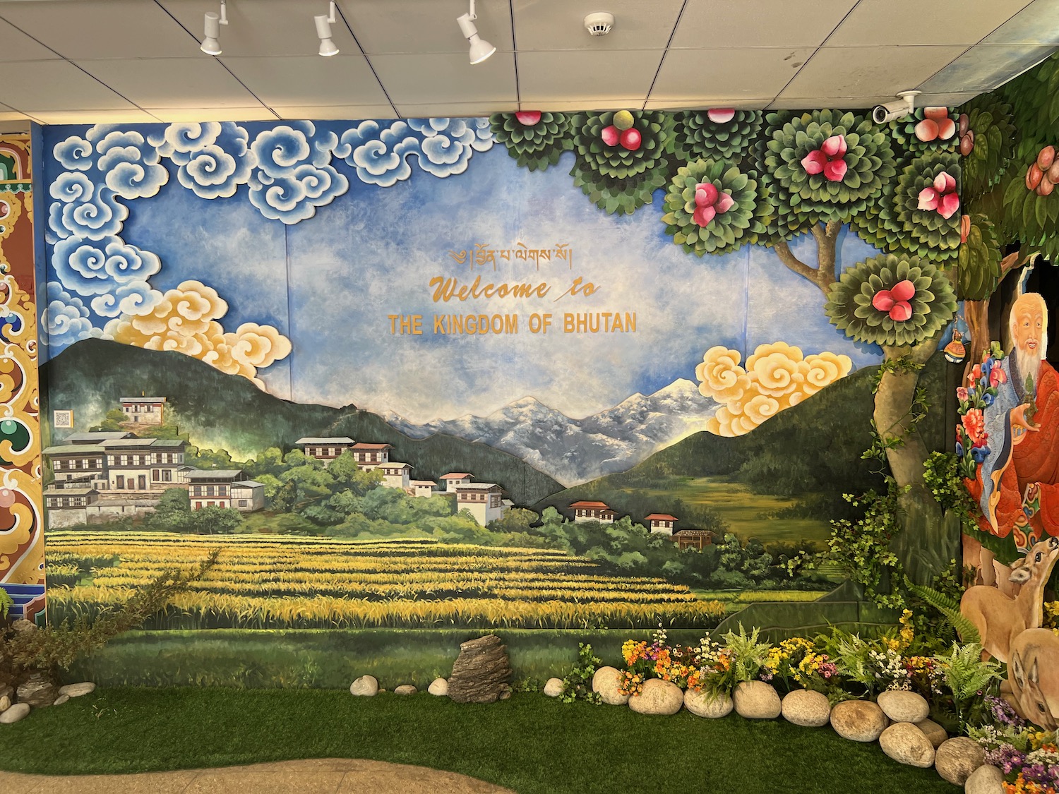 a mural of a landscape and a field of flowers