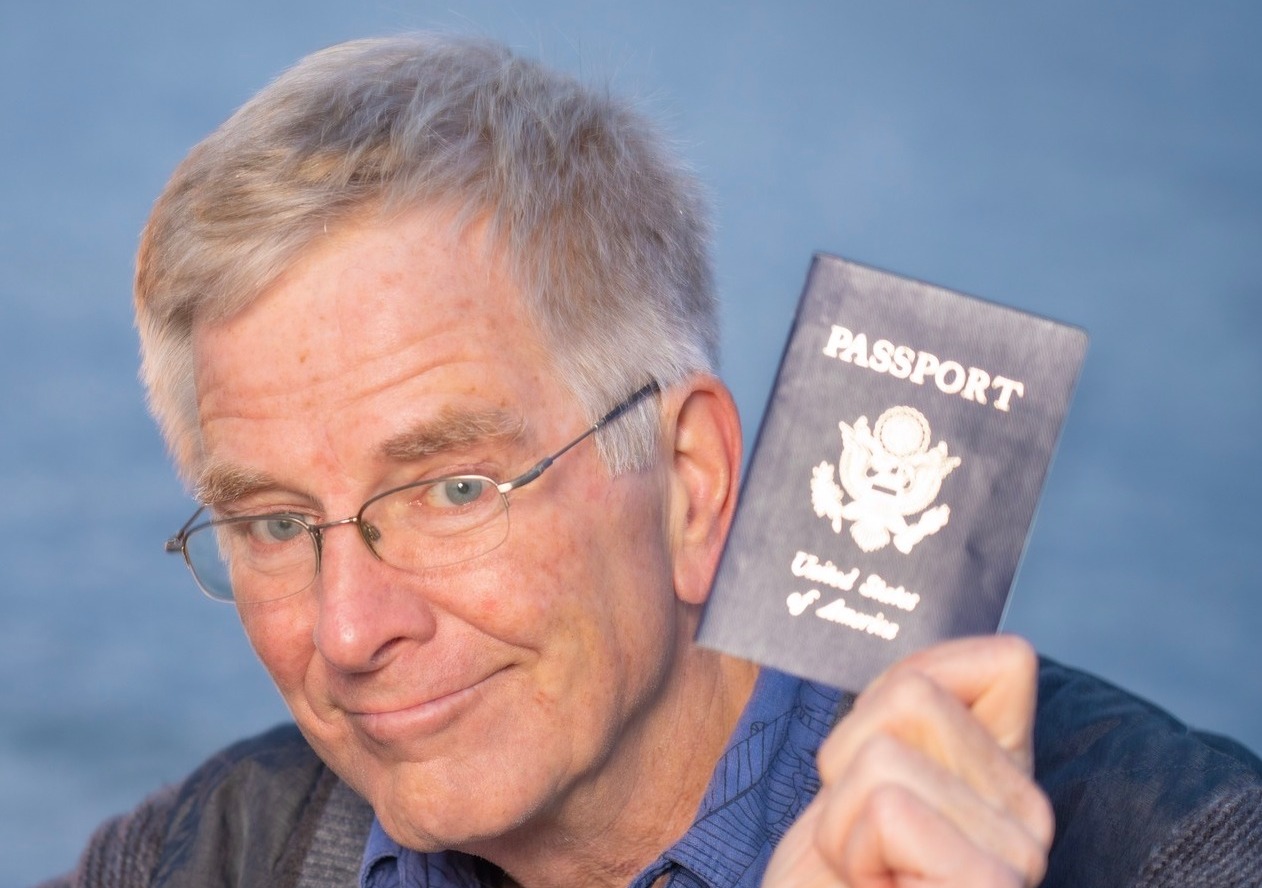 a man holding up a passport