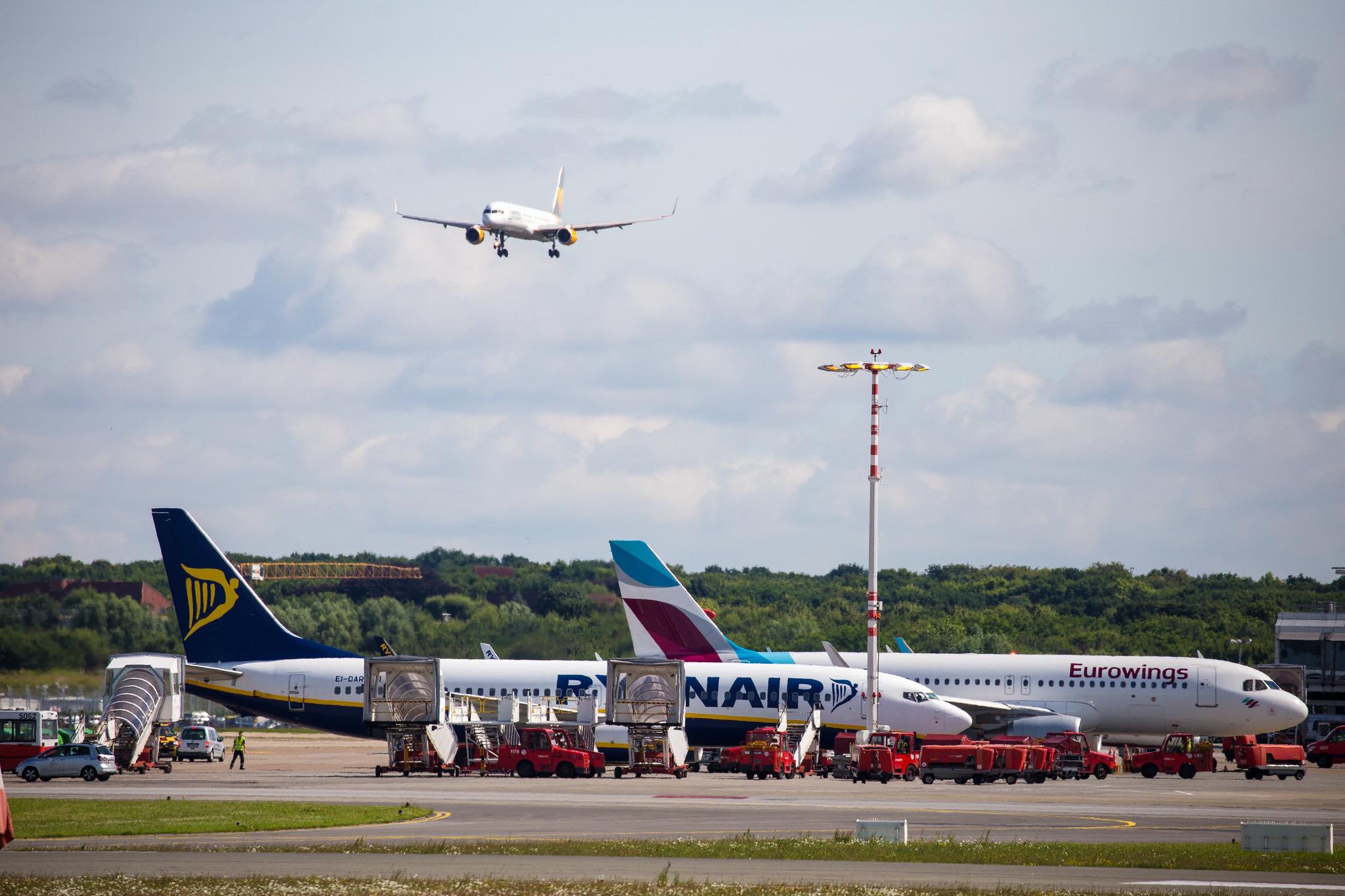 a plane flying over a runway