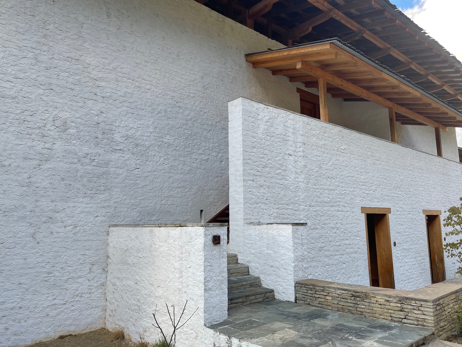 a white building with a wooden roof