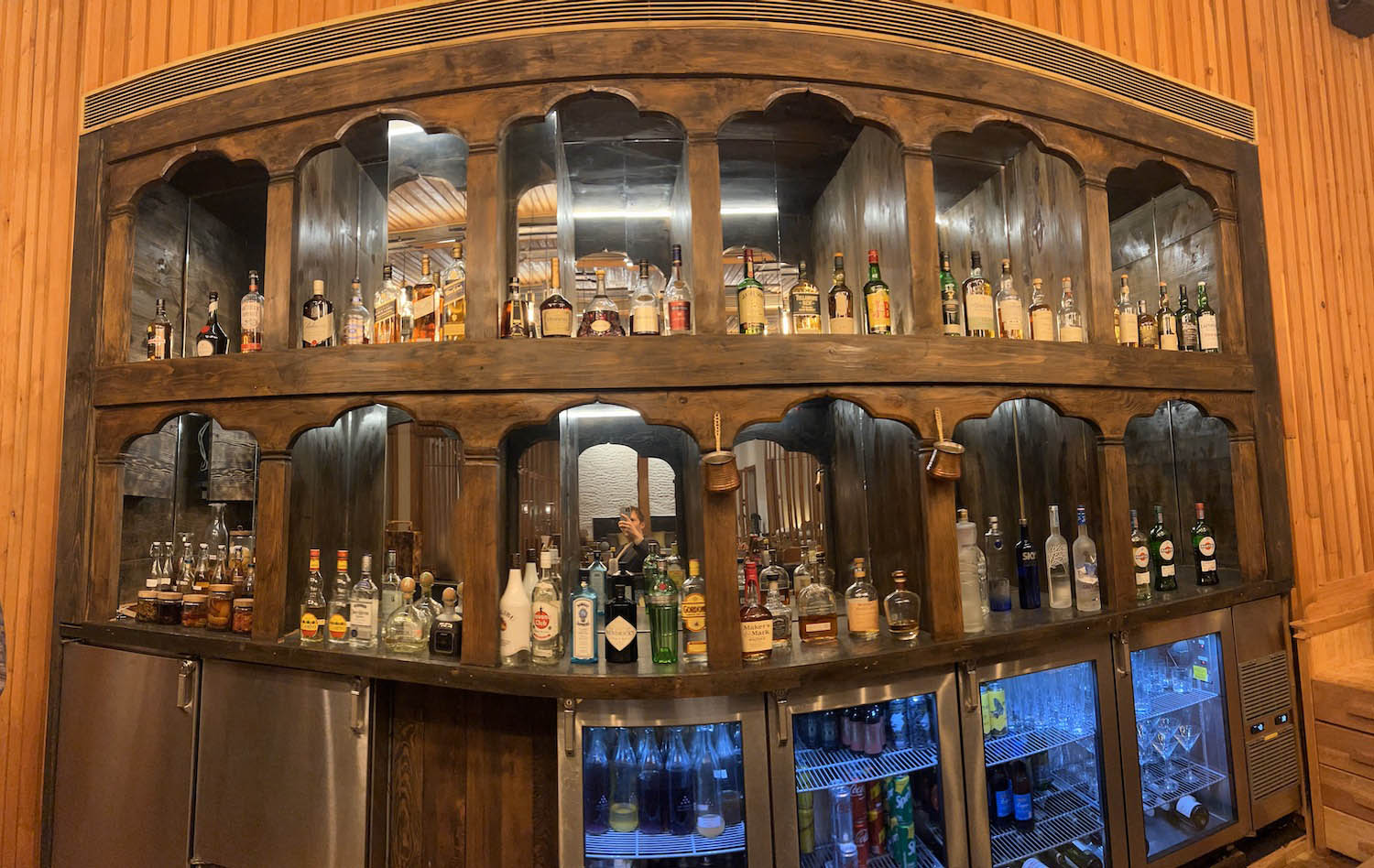 a shelf with bottles of alcohol