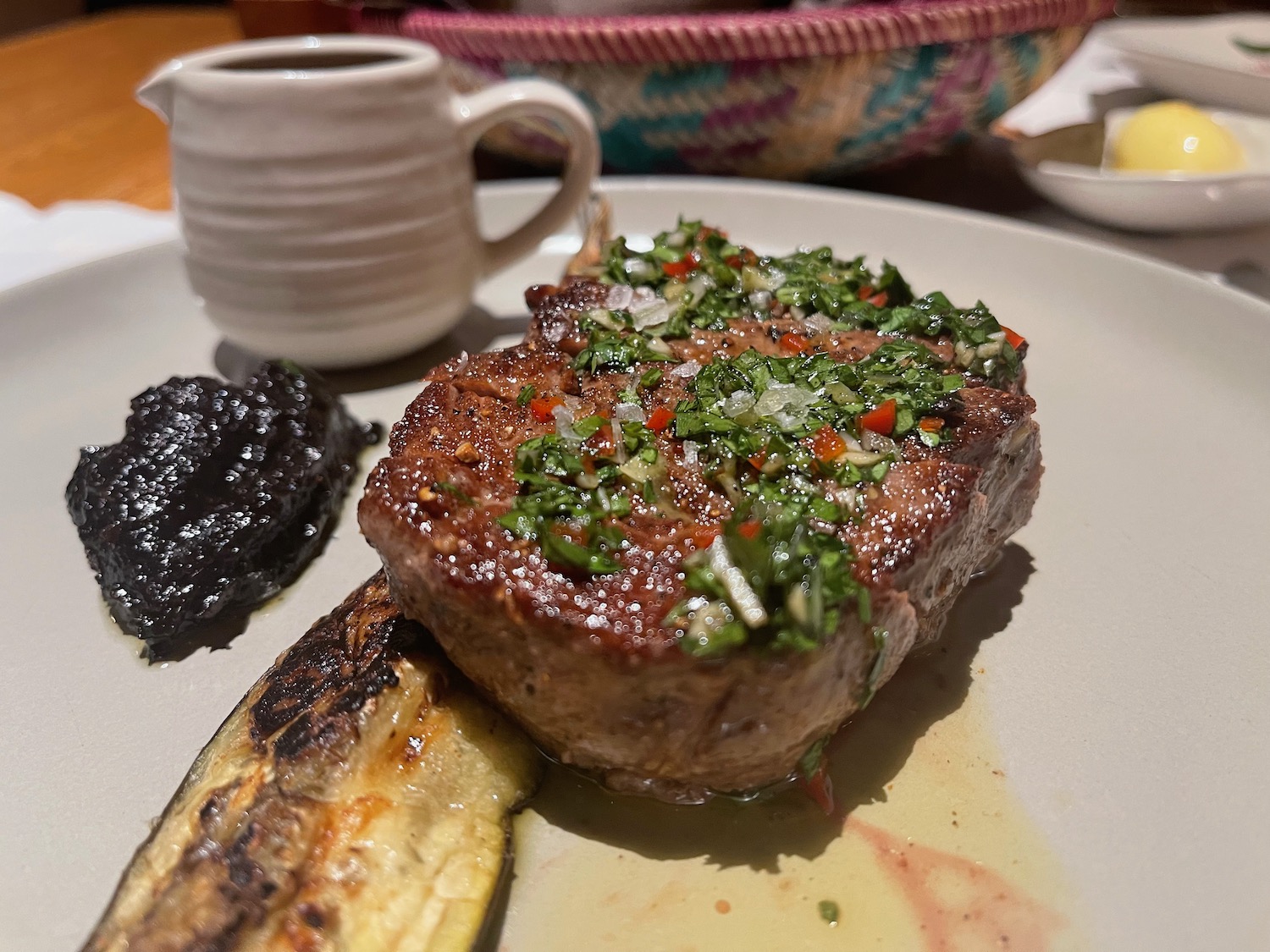 a plate of food with a cup of coffee and a basket