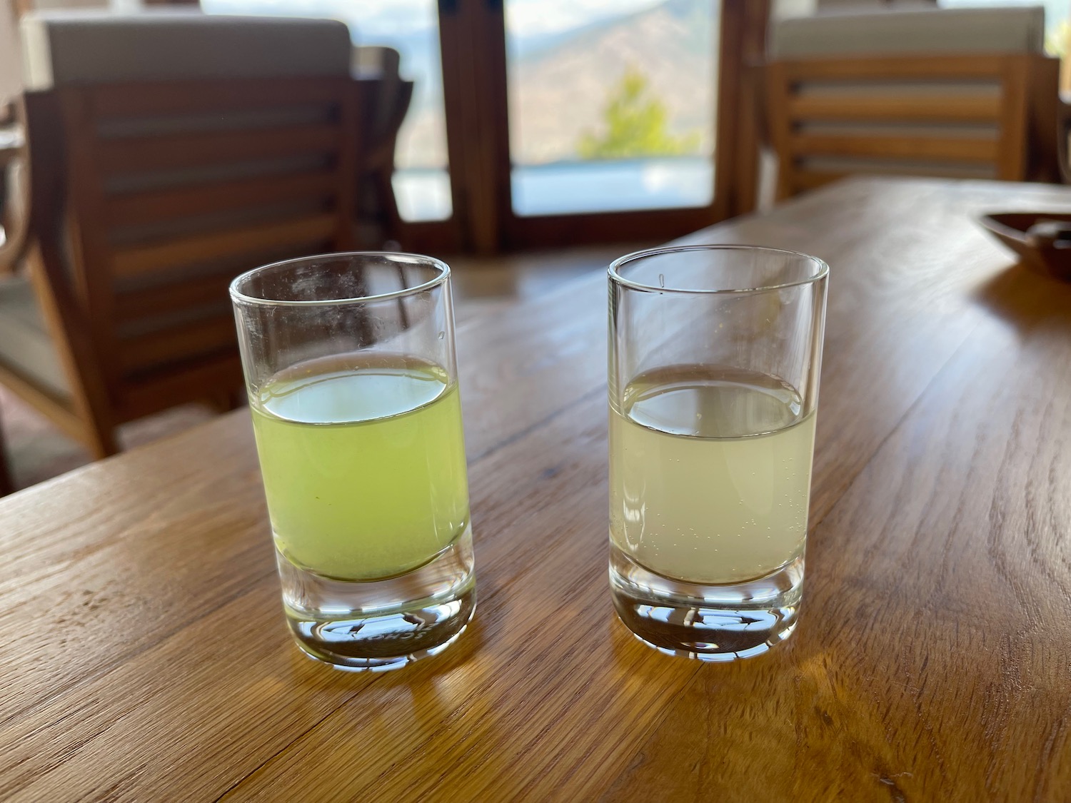 two glasses of liquid on a table