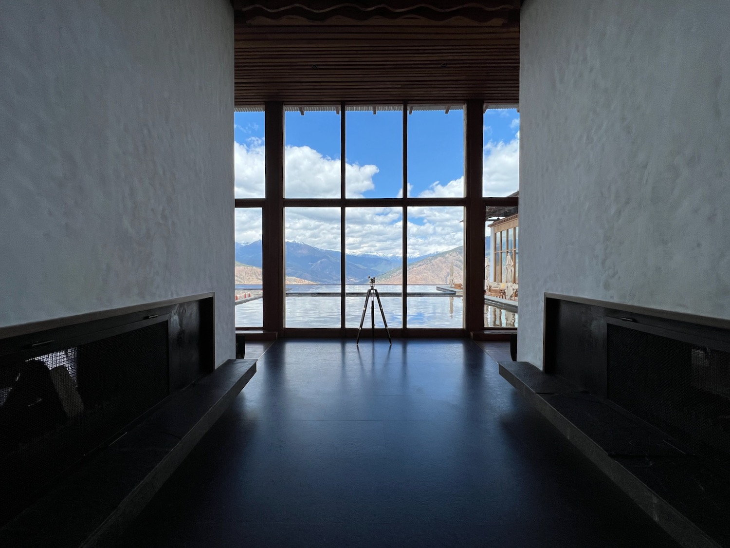 a room with a window and a view of the mountains