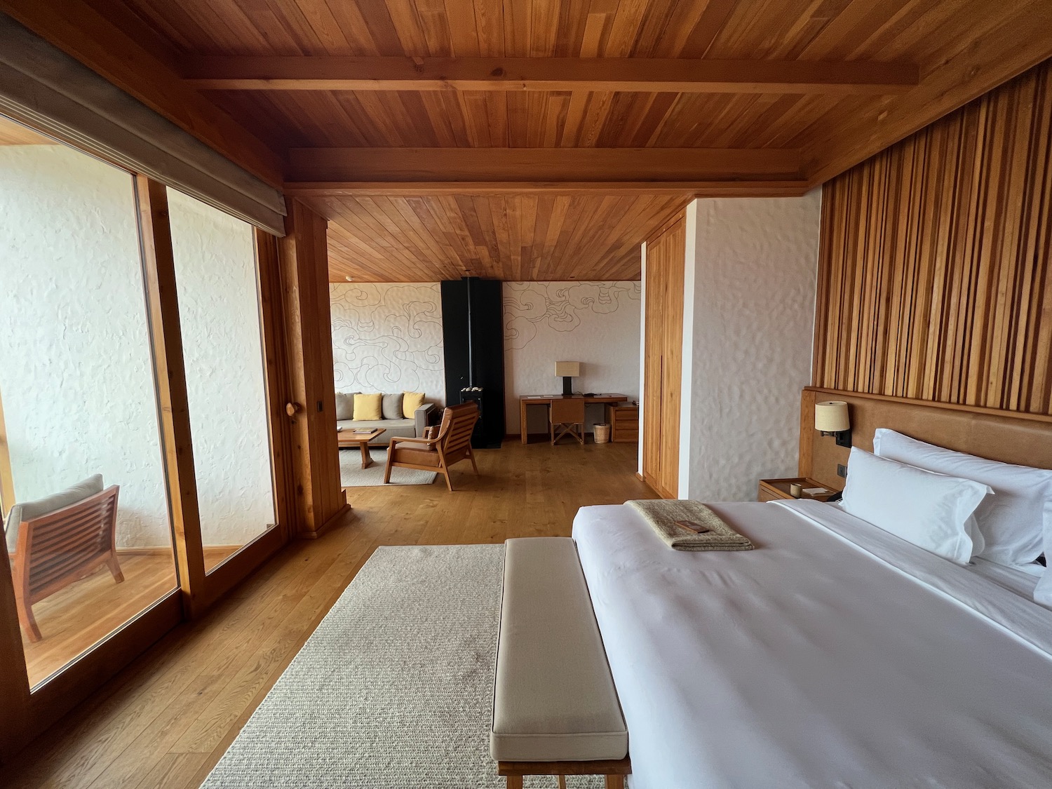 a bedroom with wood ceiling and a bed