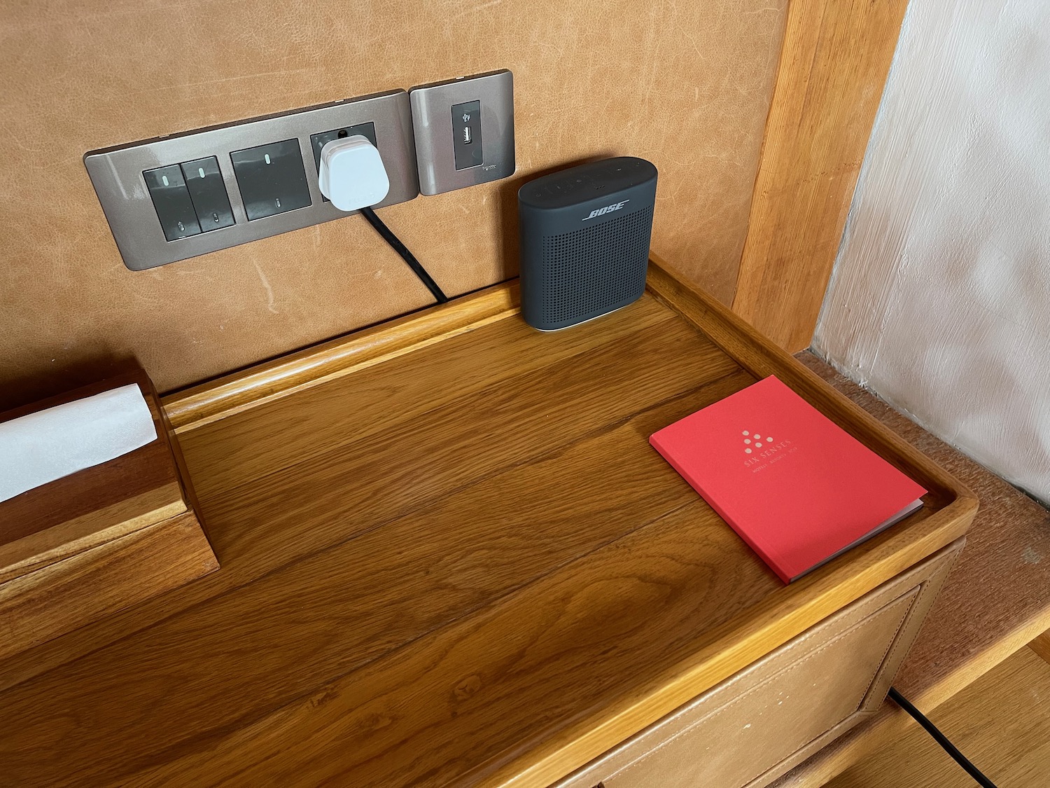 a red book on a wooden surface