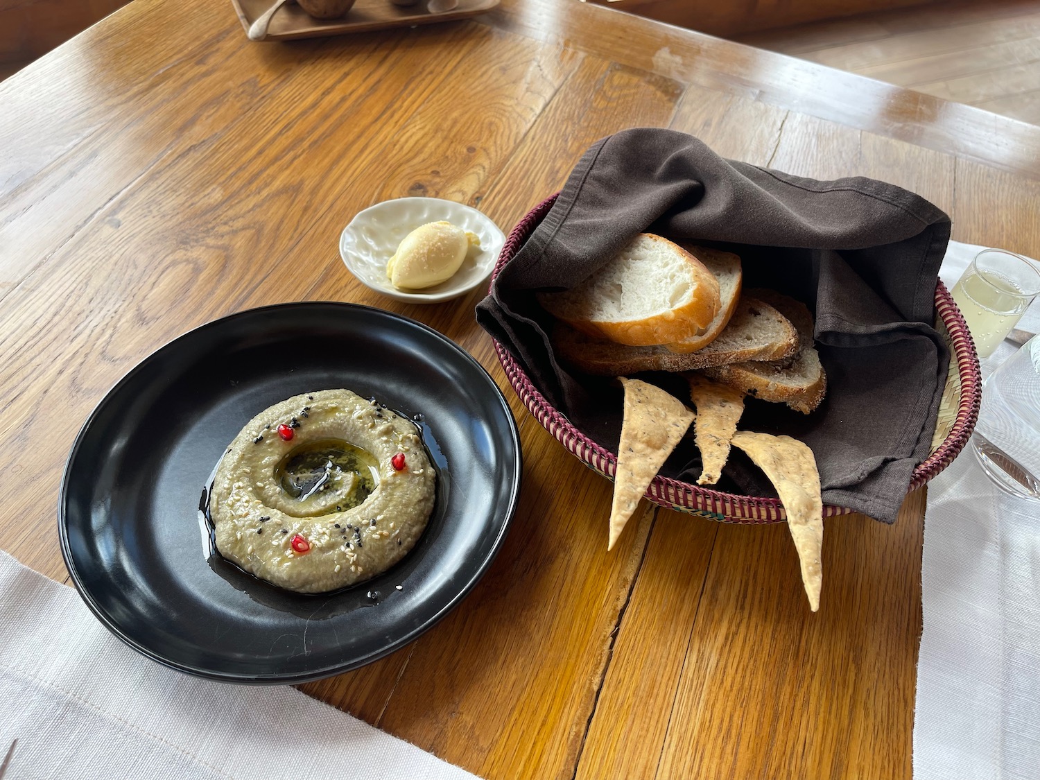 a plate of food and bread on a table