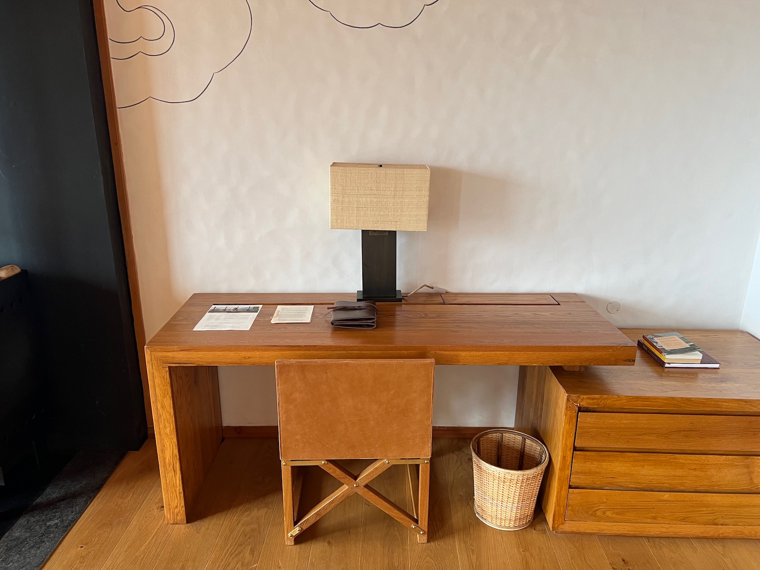 a desk with a lamp and a chair