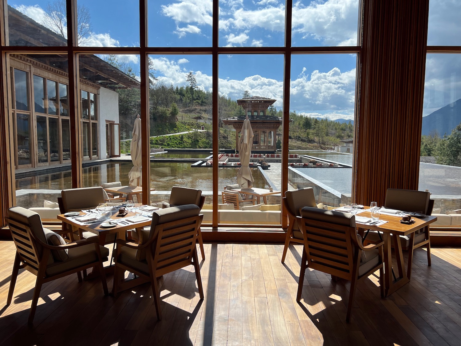 a room with a large window and tables and chairs