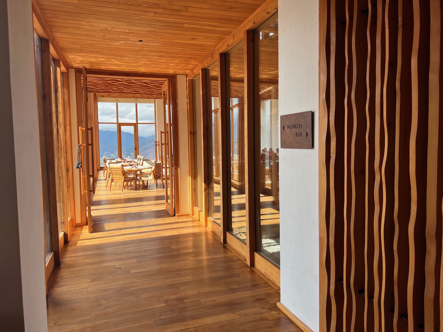 a hallway with a wood floor and a wood floor