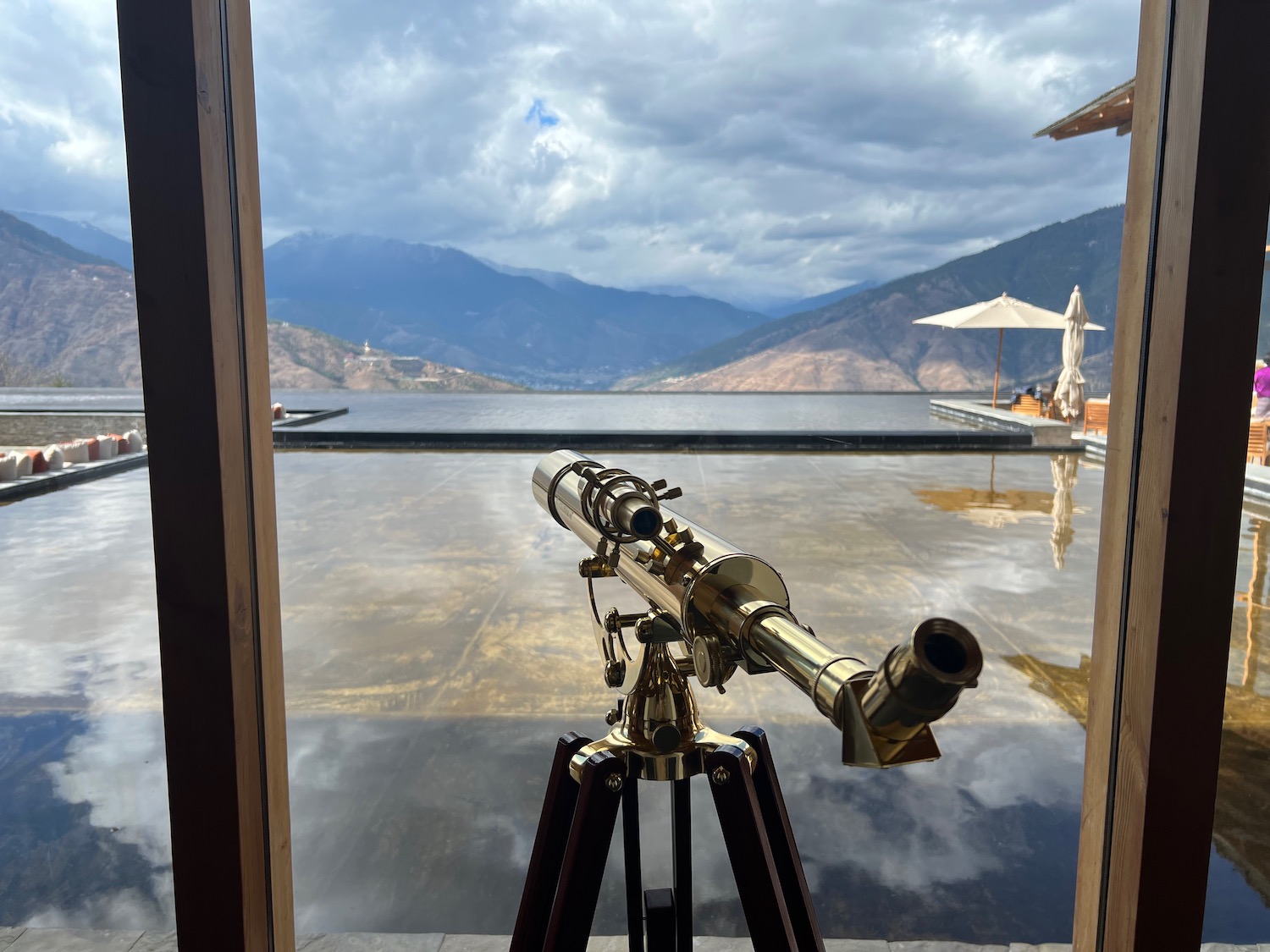 a telescope on a tripod overlooking a body of water