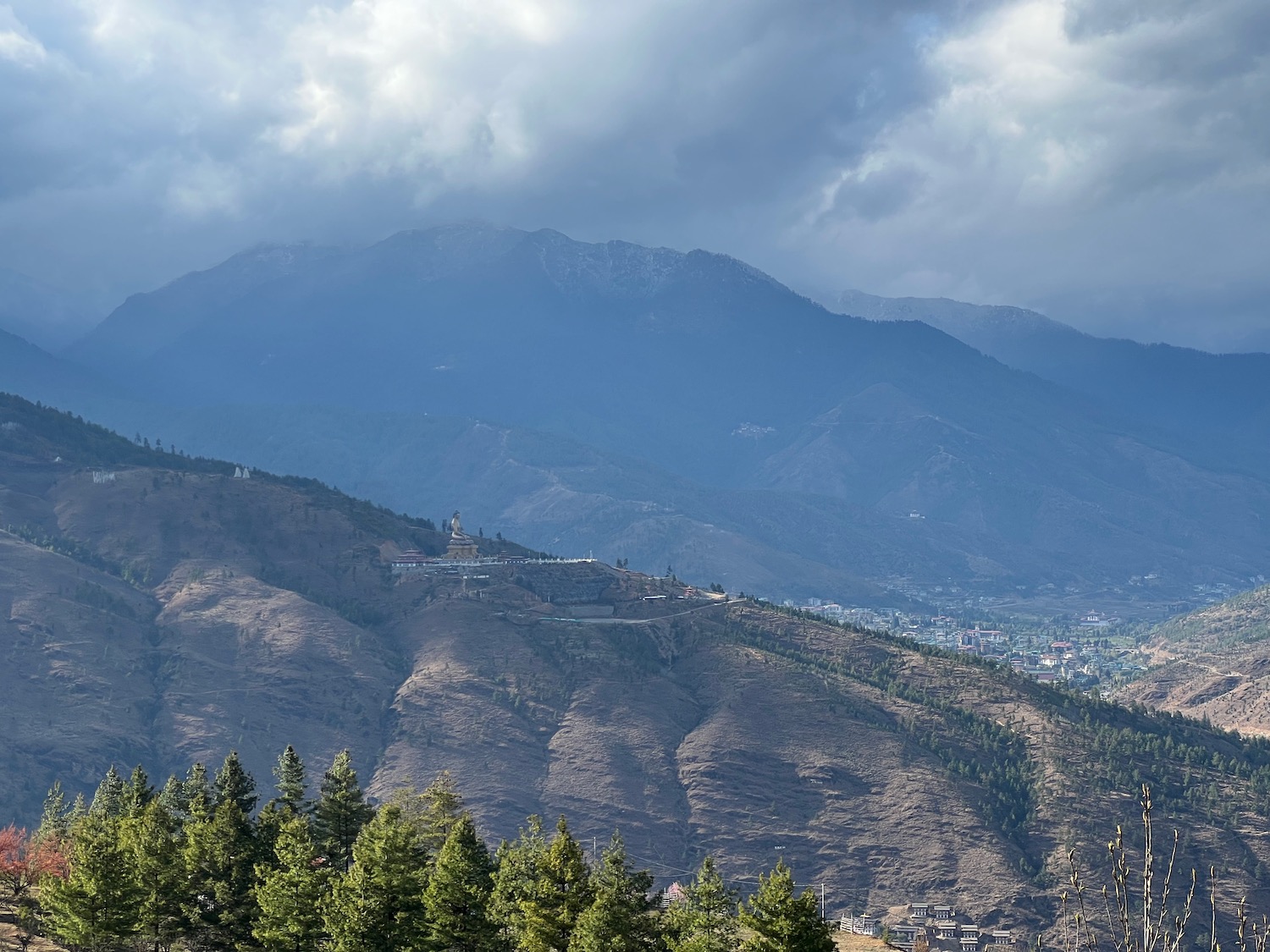 a mountain with trees and buildings