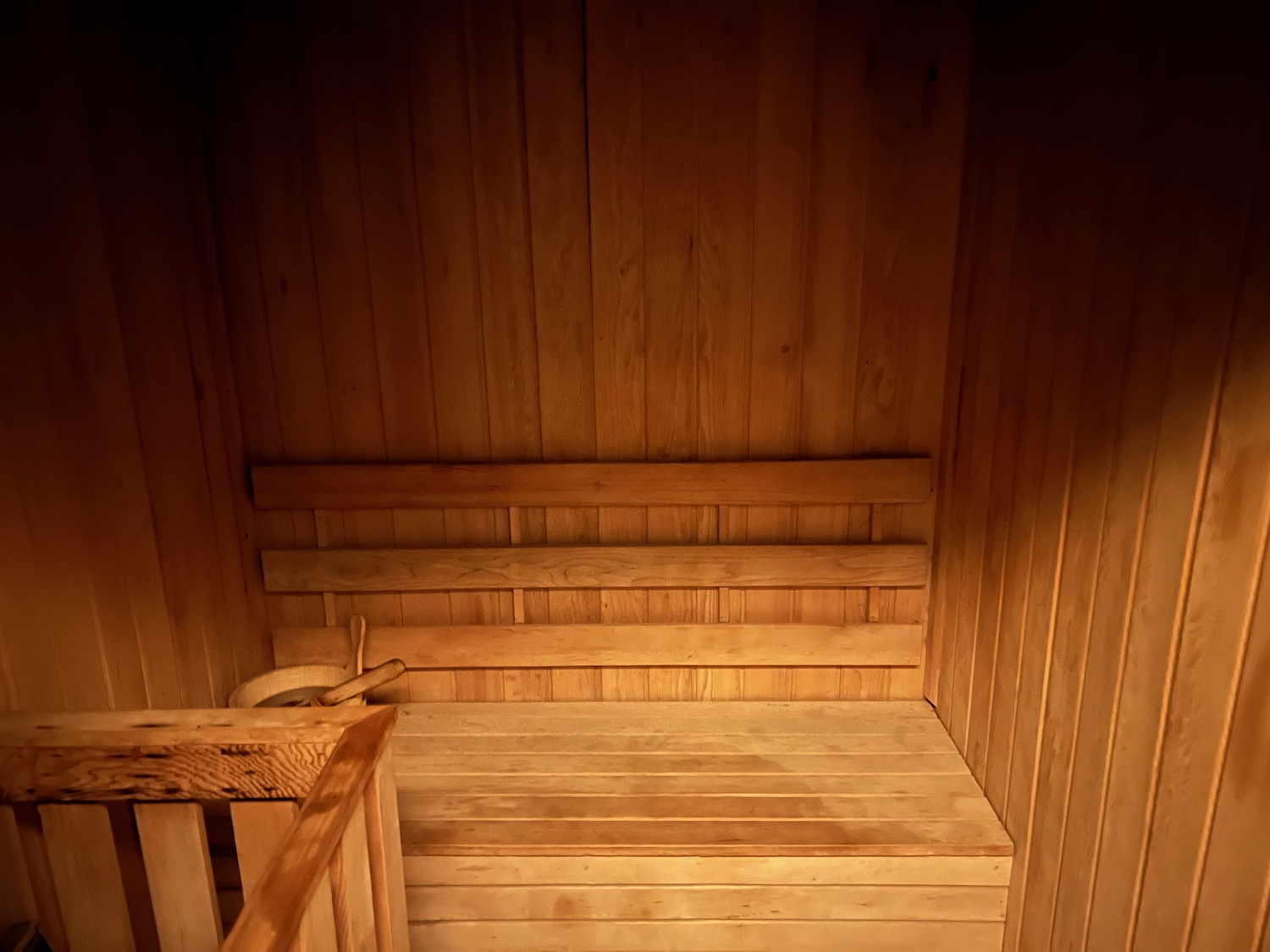 a wooden sauna with a railing