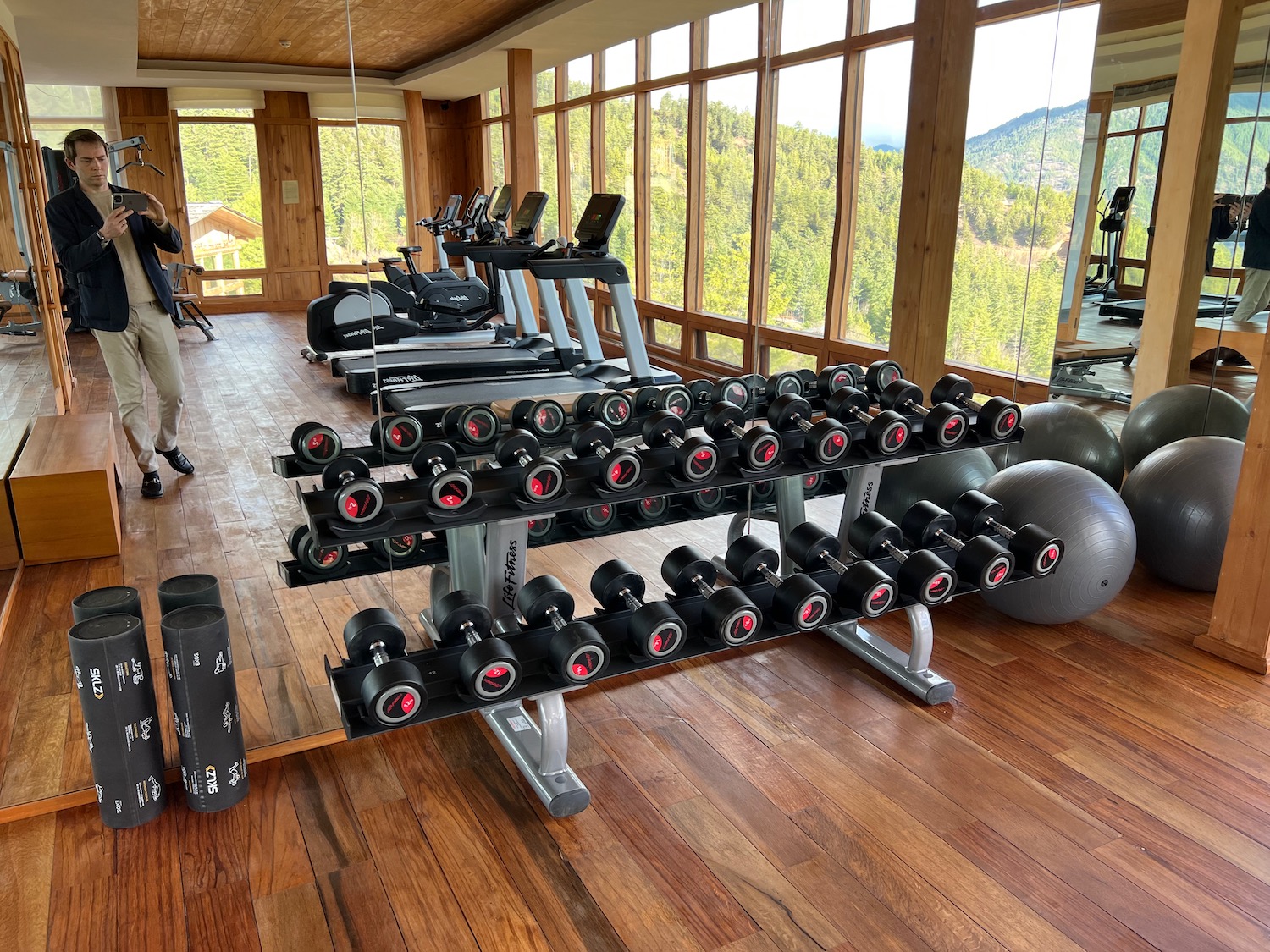 a room with a large rack of weights and exercise equipment