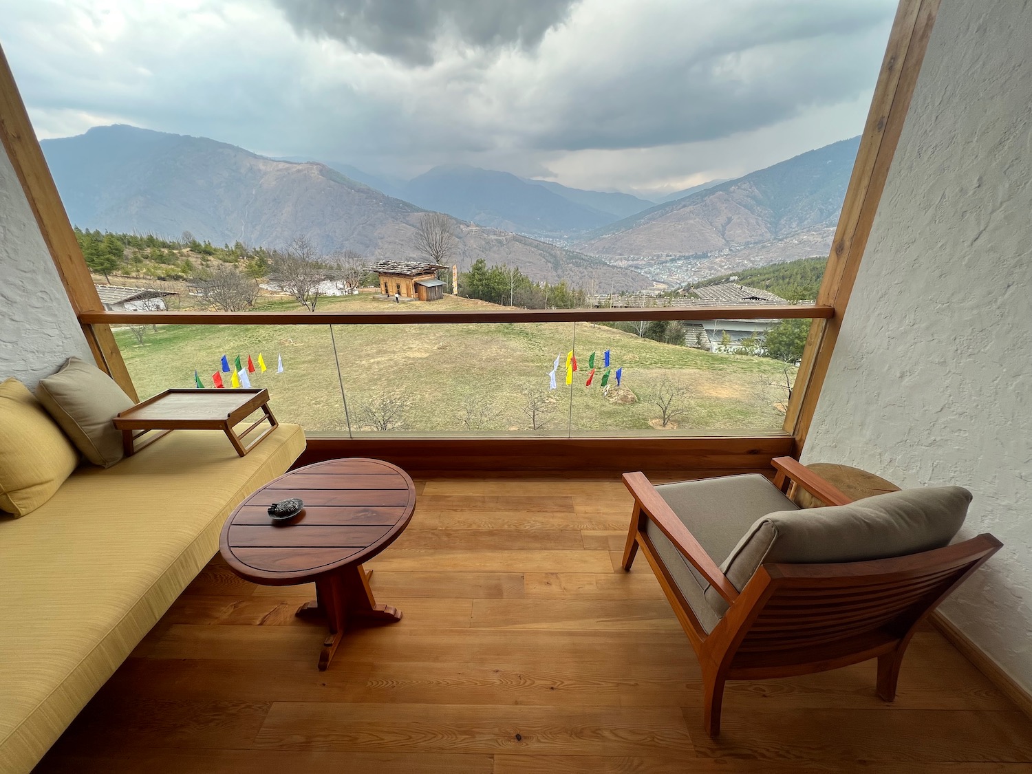 a balcony with a view of mountains and a city