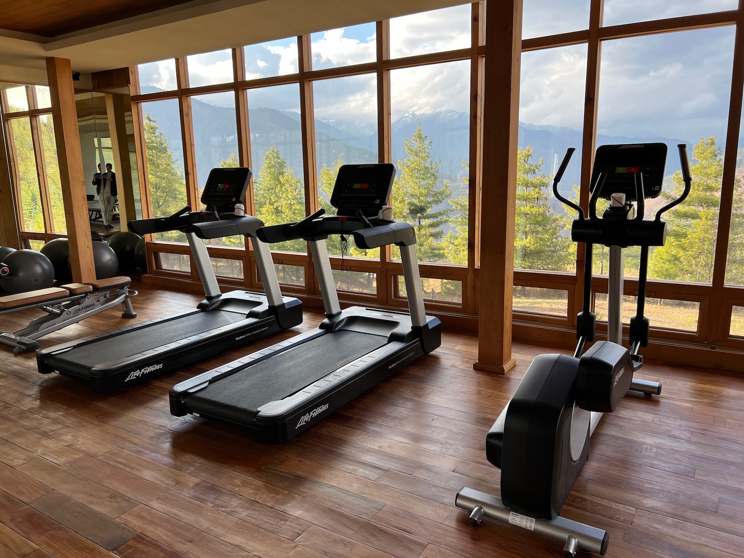 a group of treadmills in a room with large windows