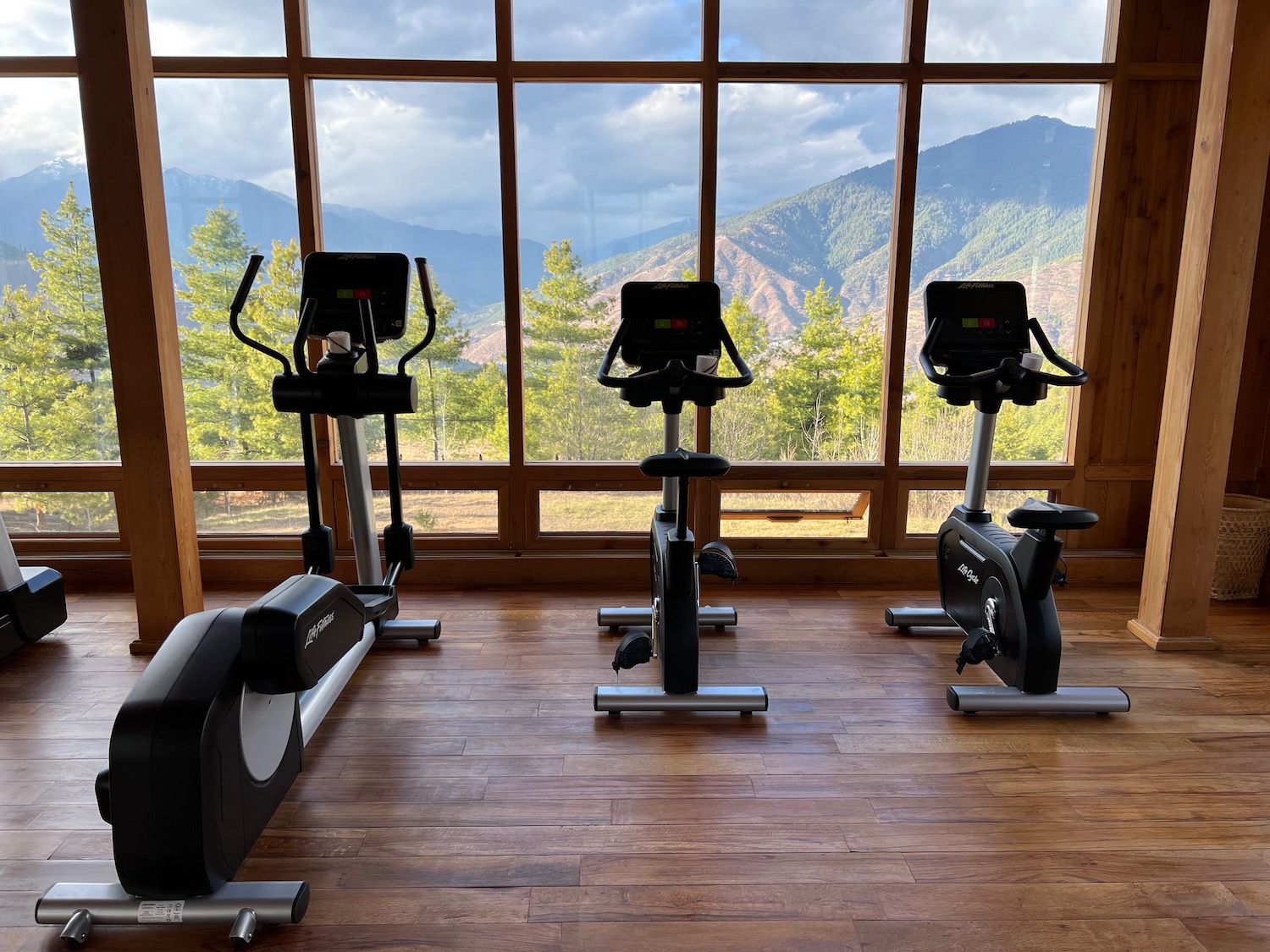 exercise bikes in a room with a view of mountains in the distance