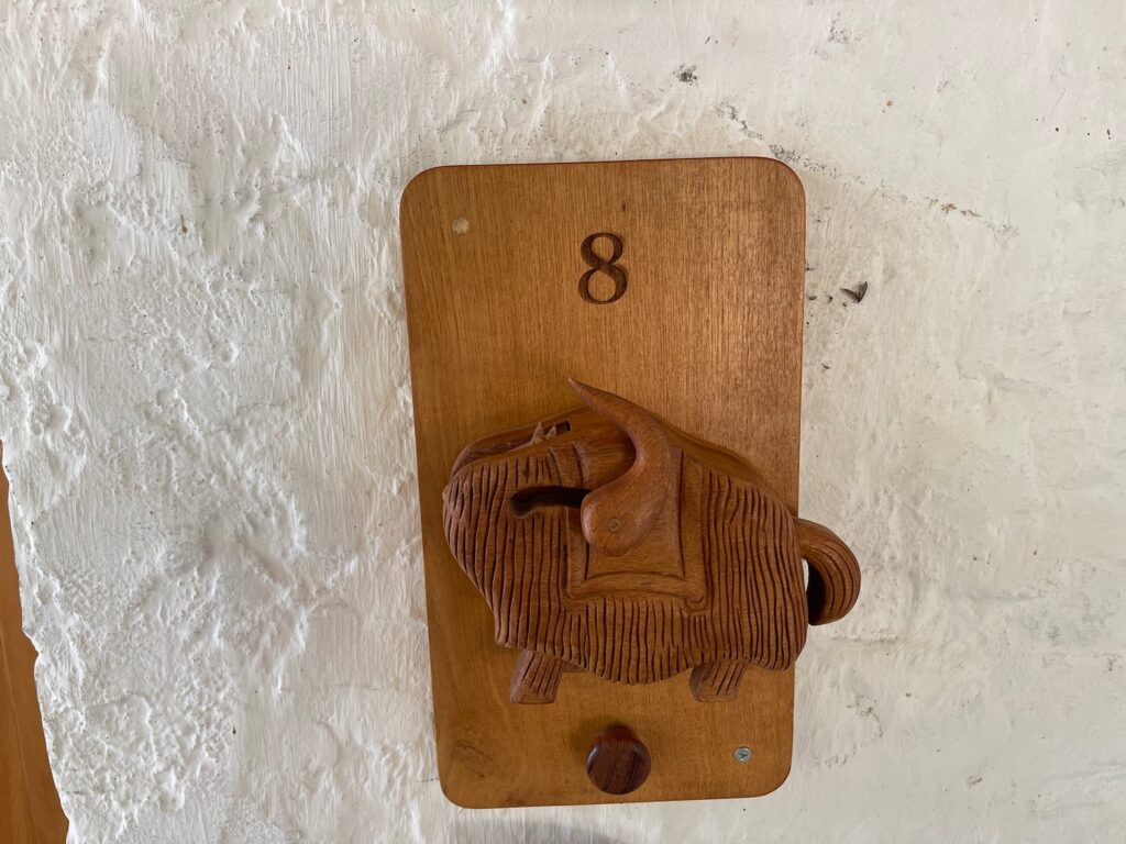 a wooden elephant on a wall