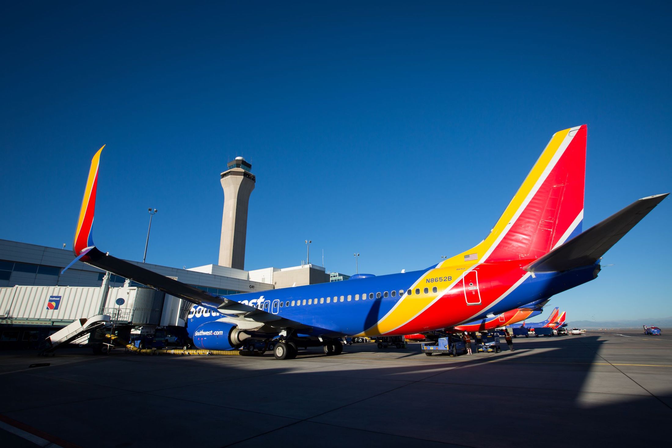 a colorful airplane parked at an airport