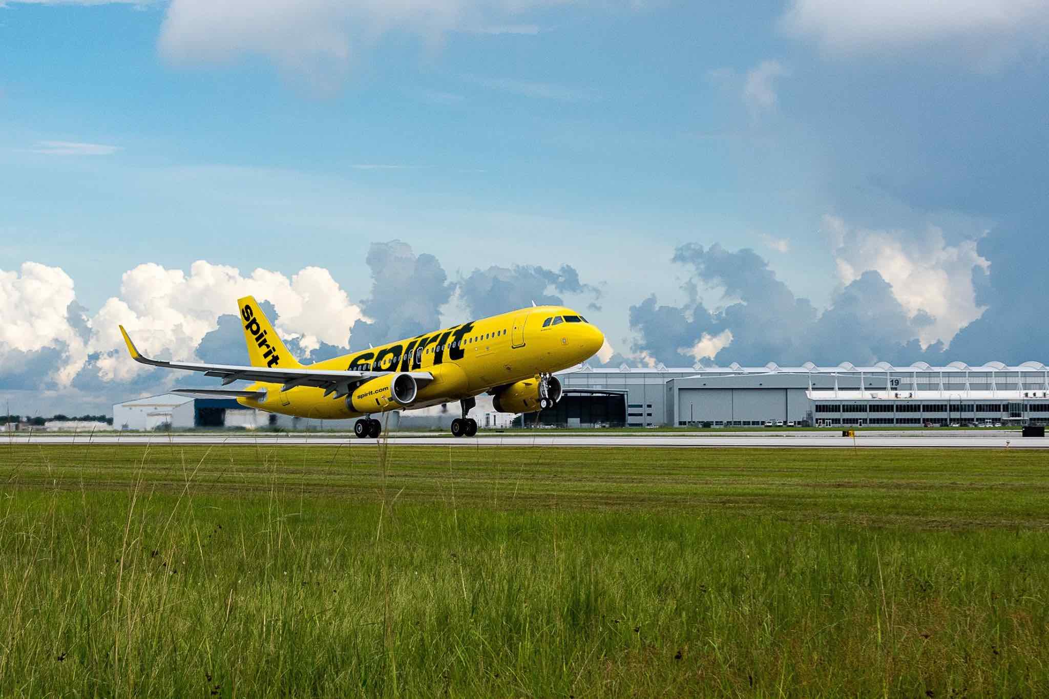 a yellow airplane on a runway