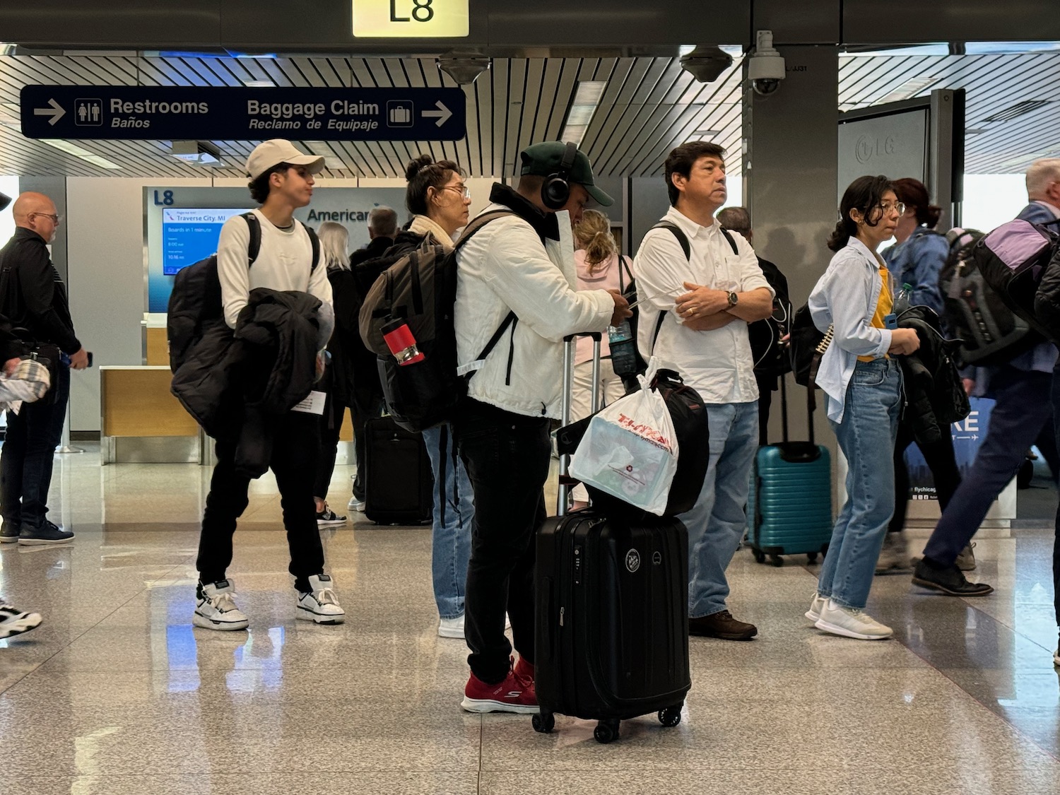 a group of people with luggage in an airport