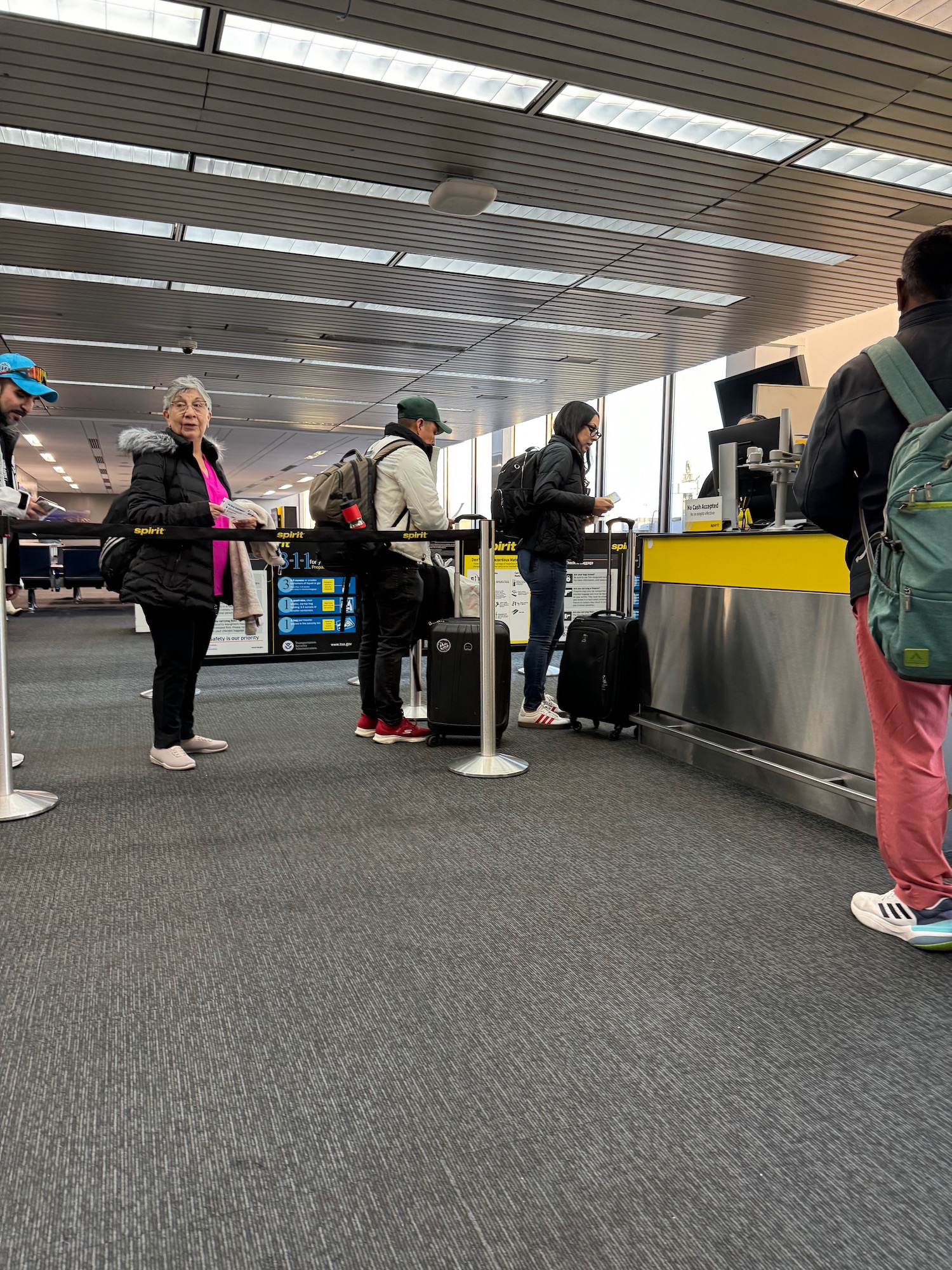 people standing in a line at an airport