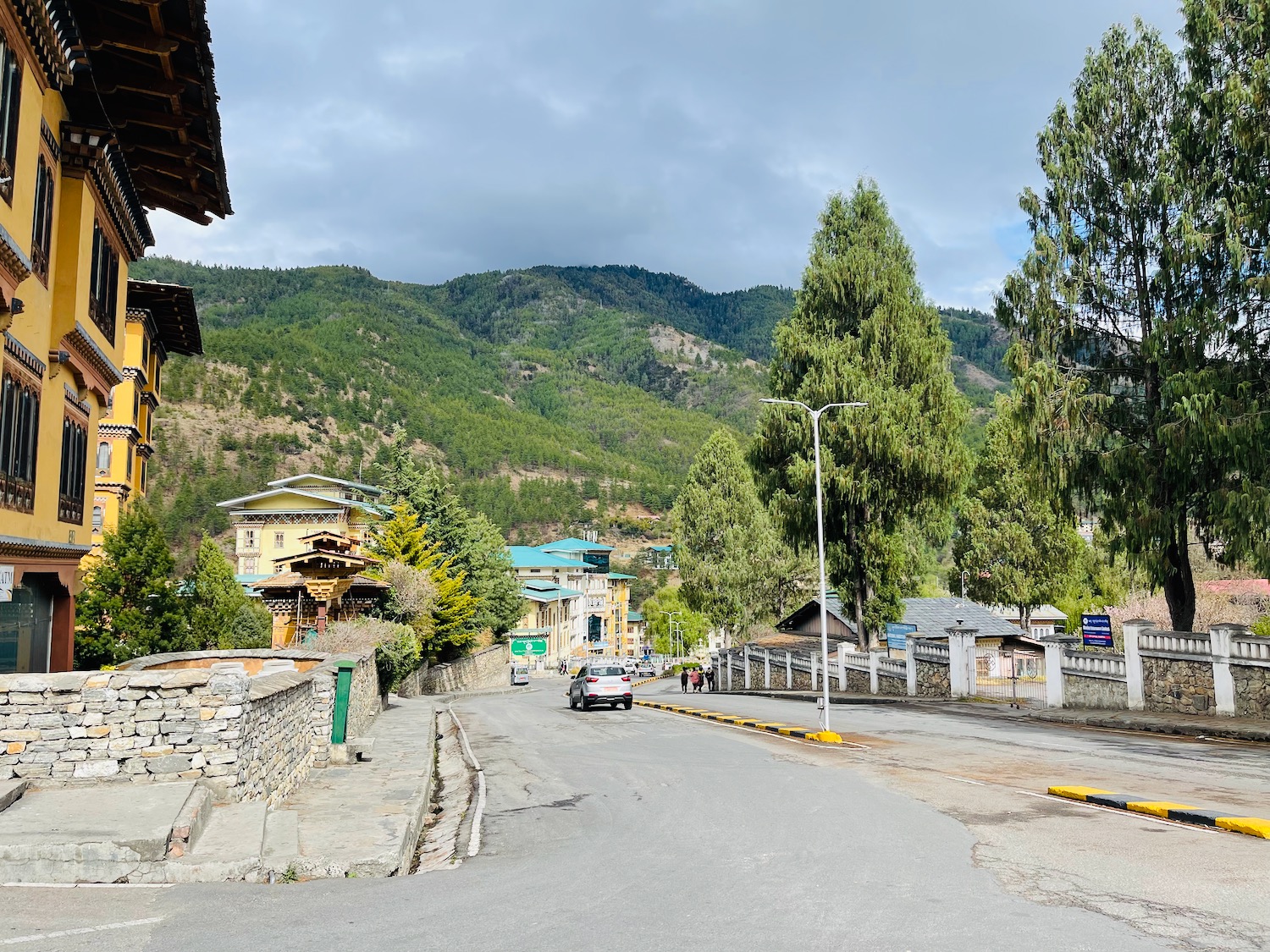 a road with buildings and trees in the background