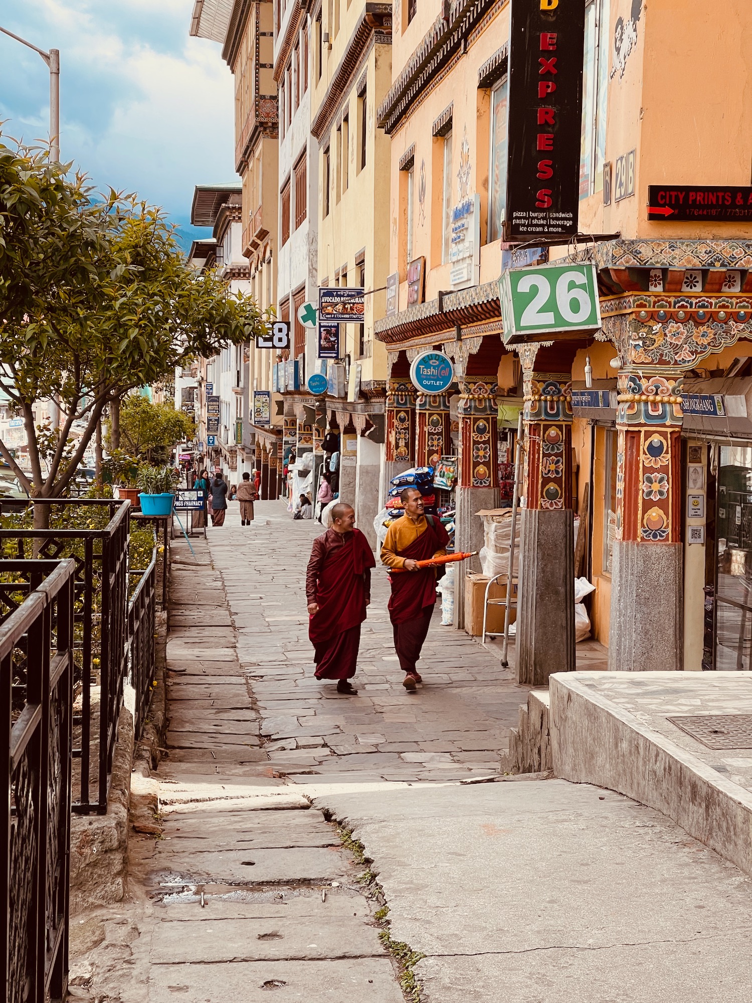 two people walking down a street