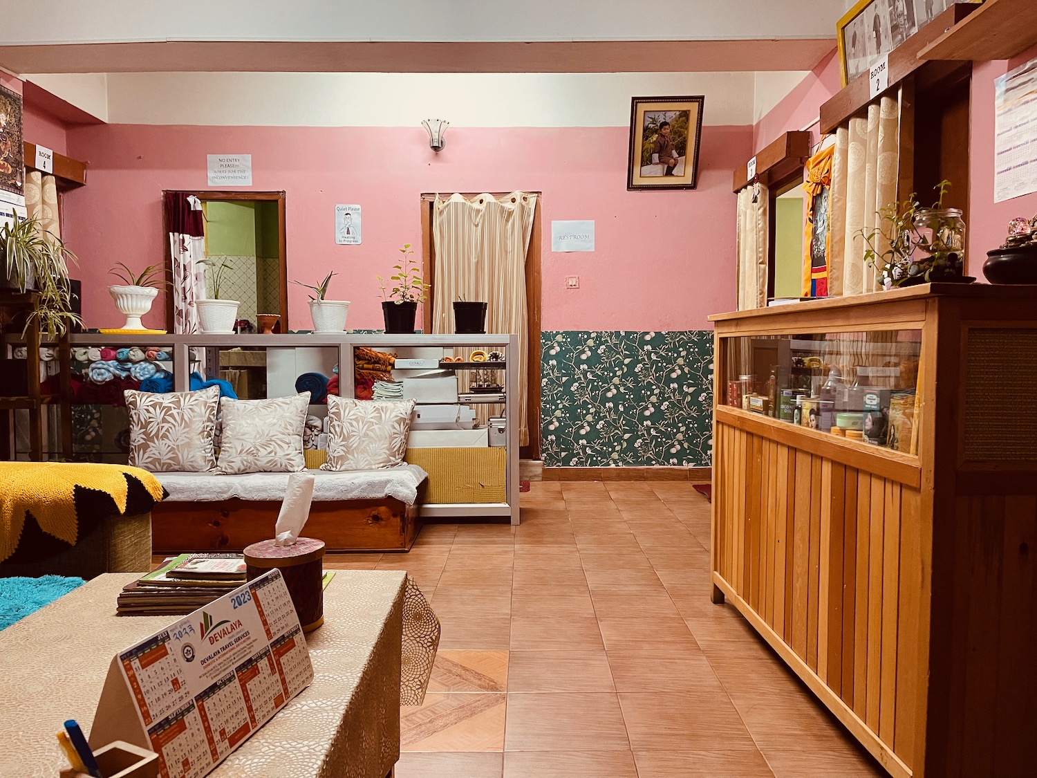 a room with a pink wall and a couch