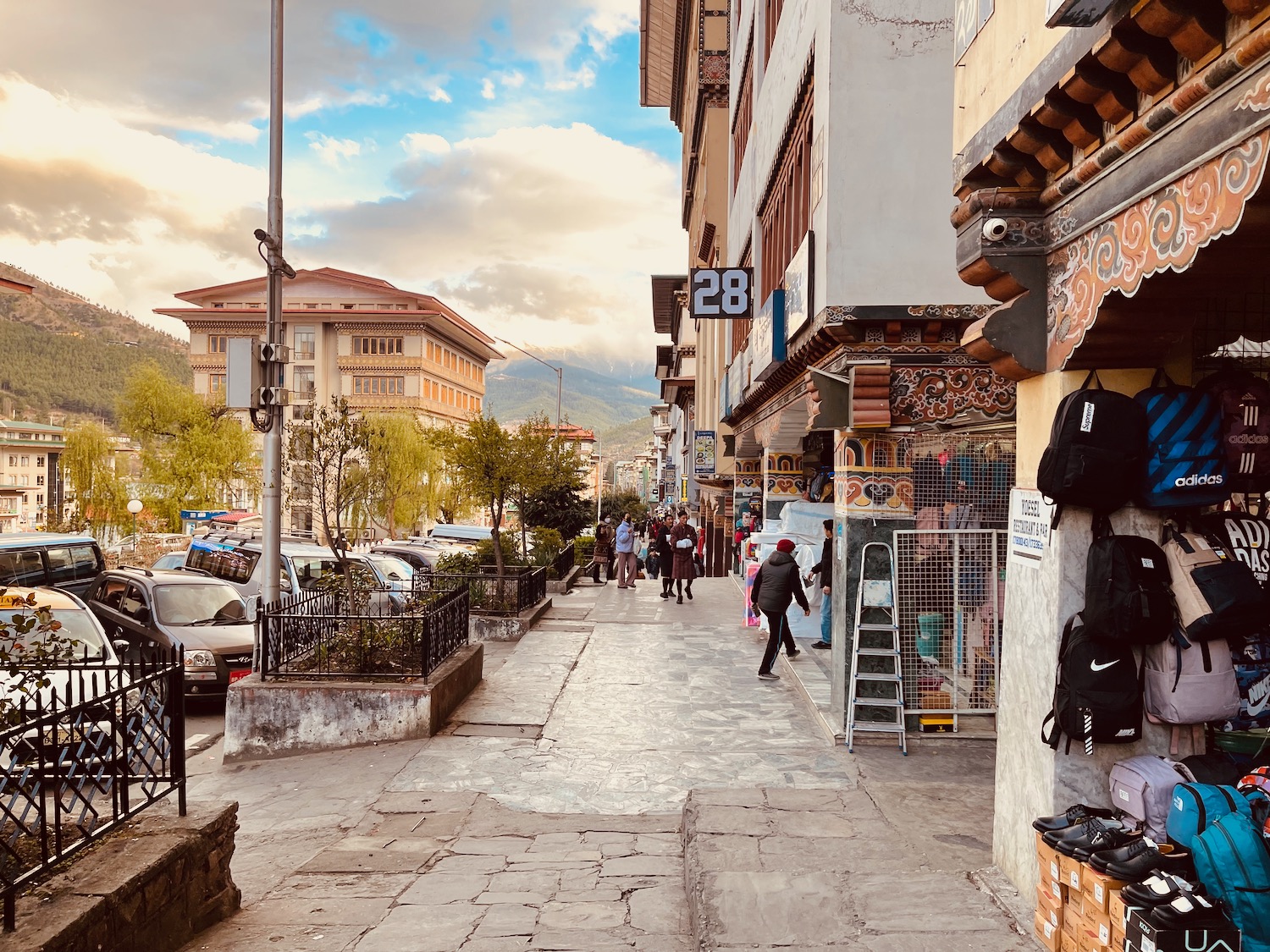 a street with buildings and people walking on it