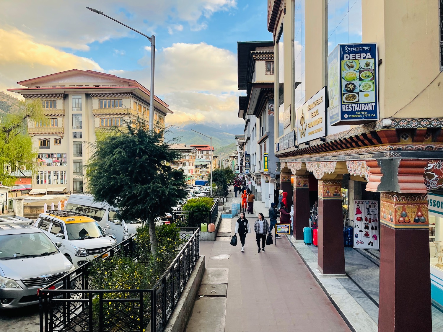 people walking on a sidewalk in a city