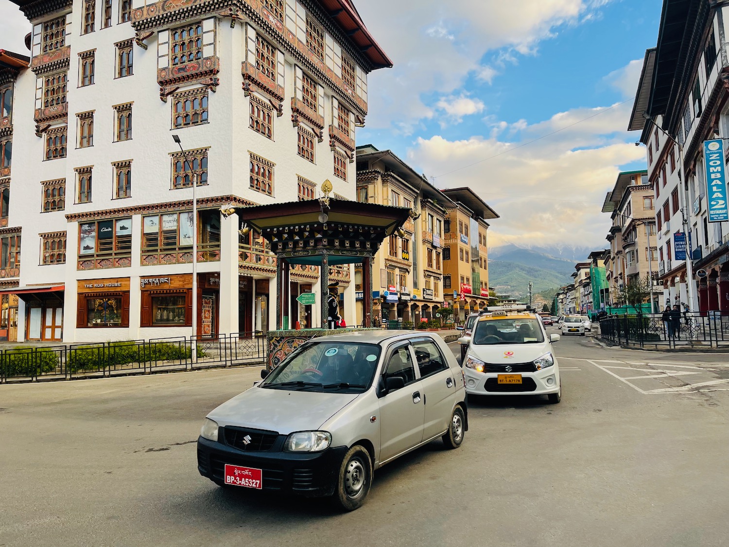 cars parked cars on a street in front of a building