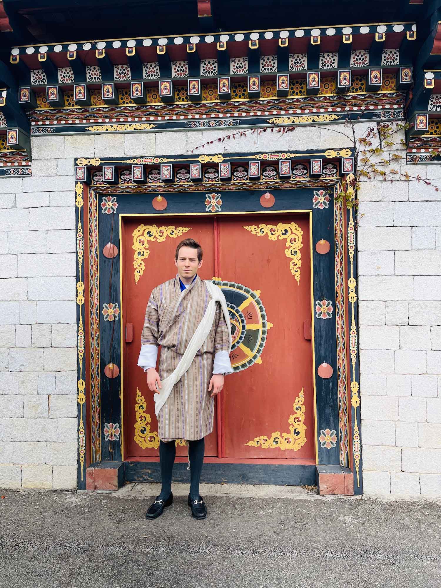 a man standing in front of a red door