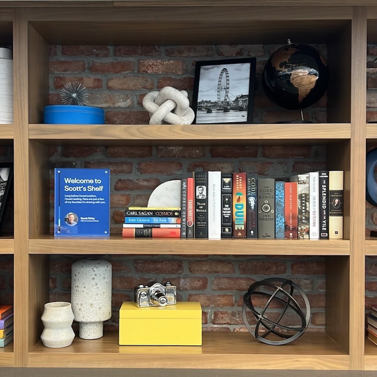 a shelf with books and objects on it