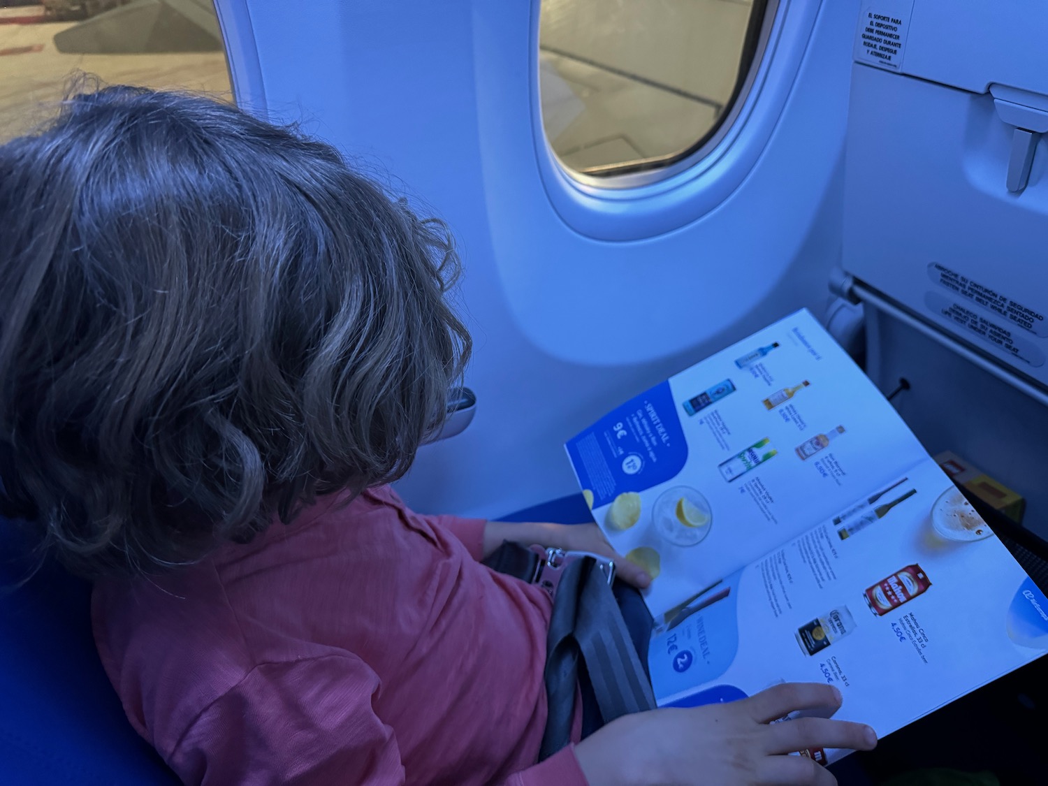 a child reading a book on an airplane