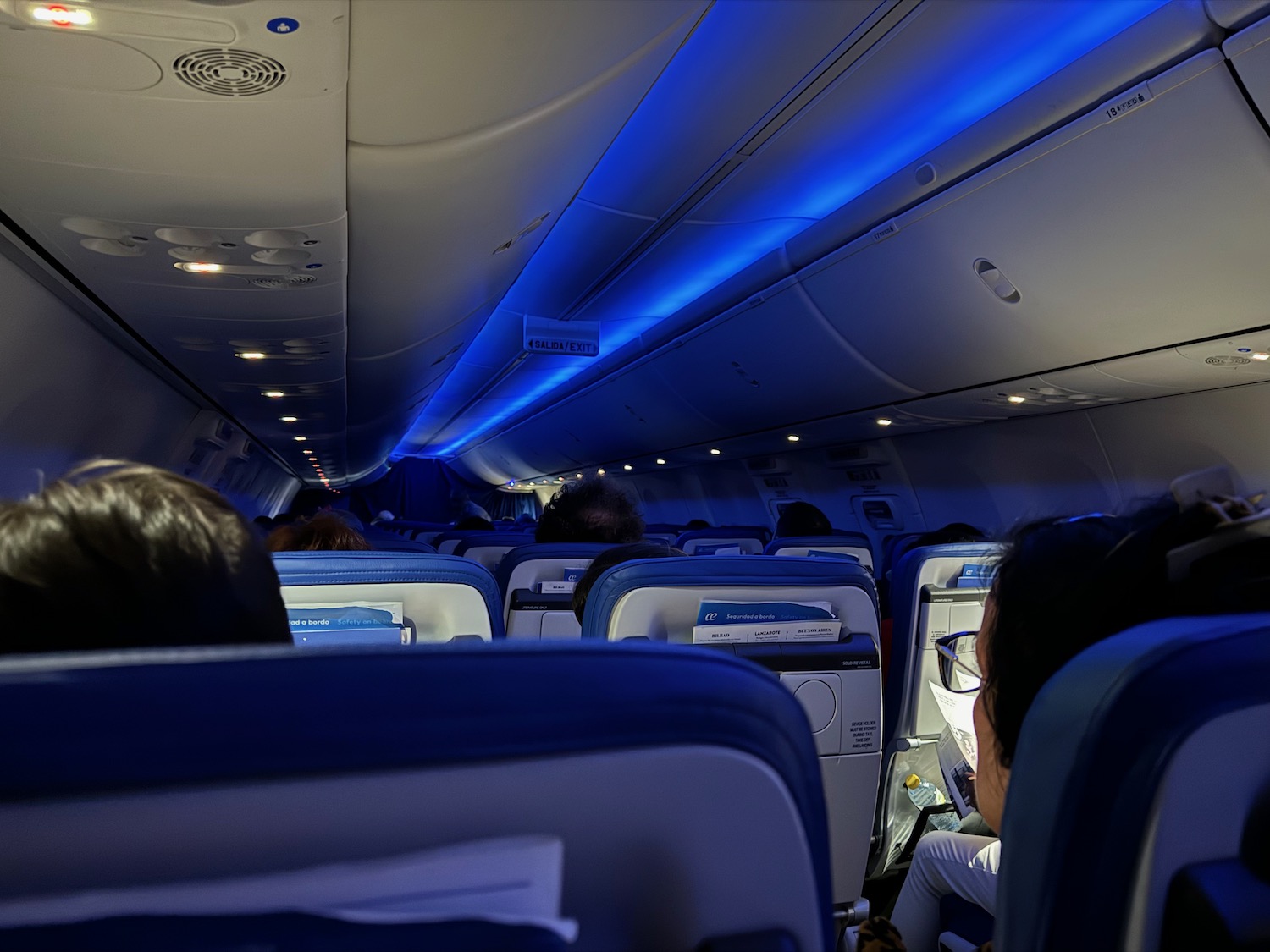 a group of people sitting in an airplane